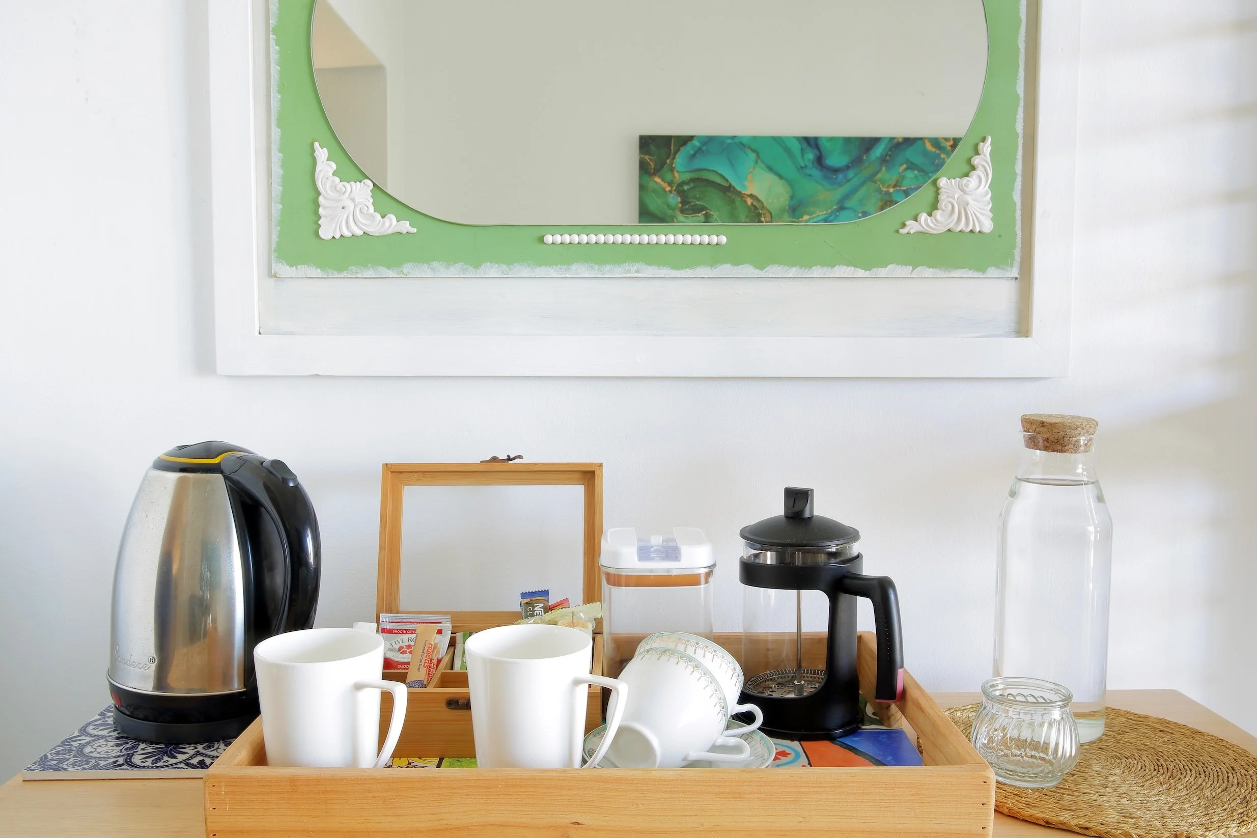 In-room tea and coffee station with kettle, French press and complimentary amenities at Mykonos Luxury Guest House.