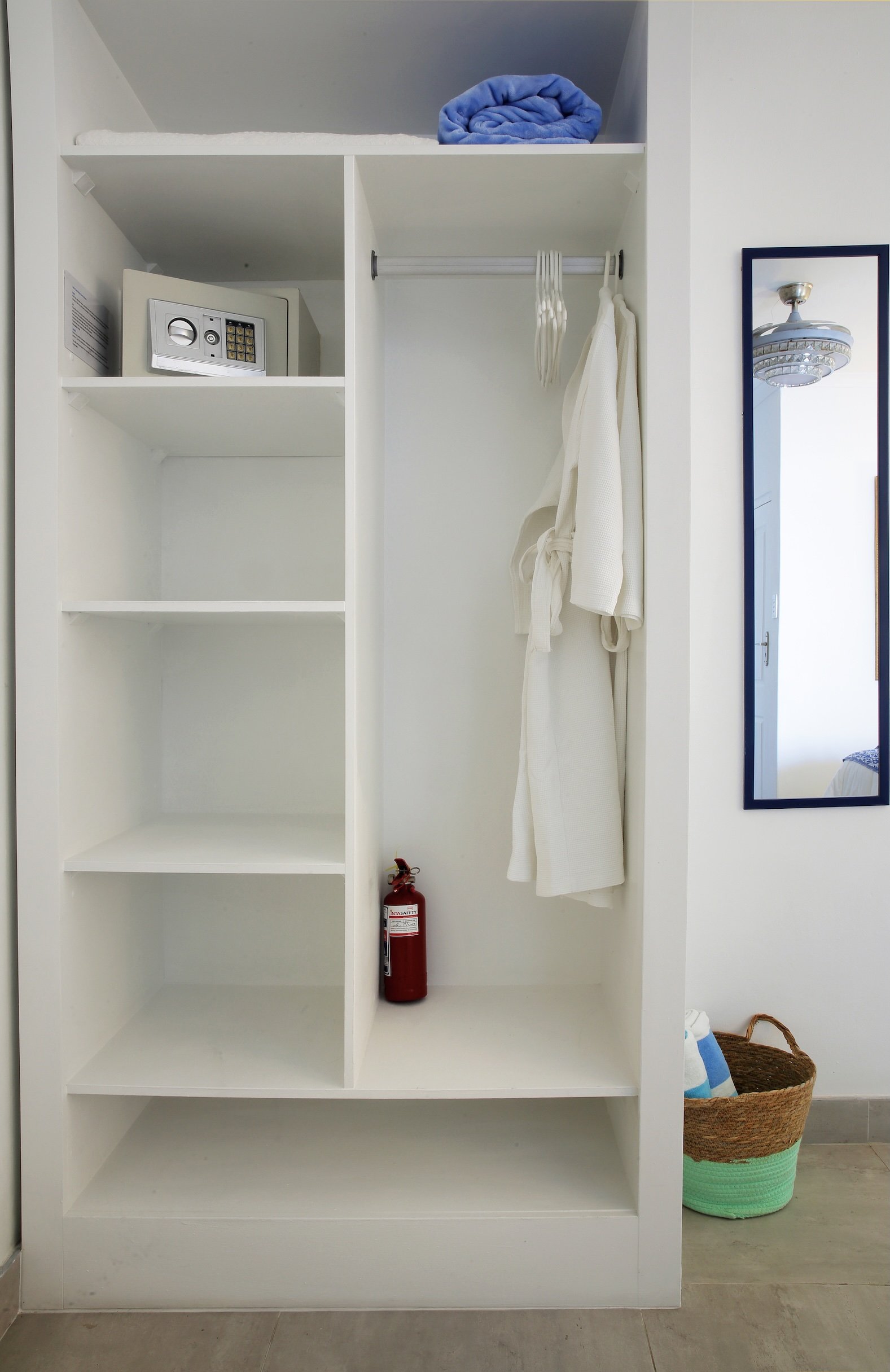 Spacious closet with safe, bathrobes and storage space in luxury St Francis Bay guest suite.