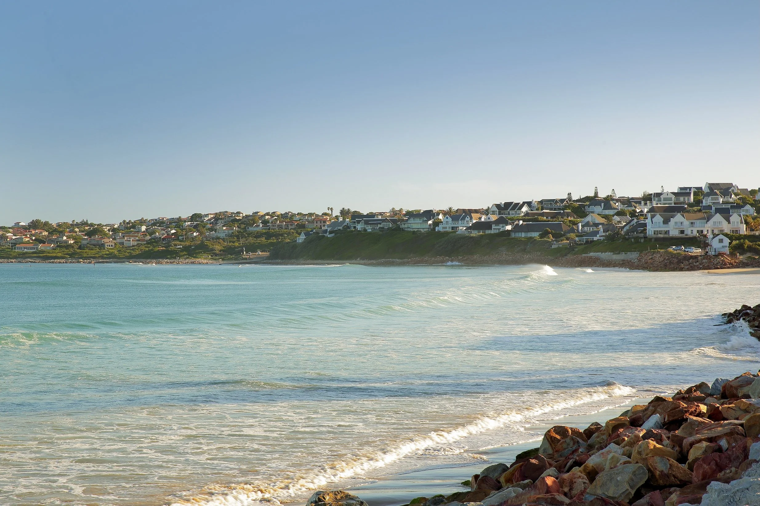 Scenic coastline of St Francis Bay with ocean waves and seaside homes near Mykonos Luxury Guest House.