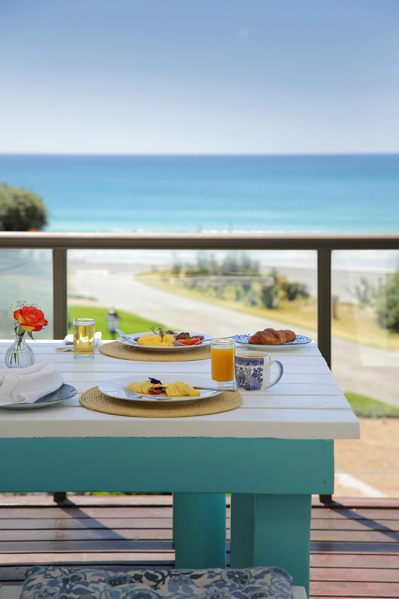 Breakfast with fresh croissants, juice and coffee overlooking the ocean at Mykonos Guest House in St Francis Bay.