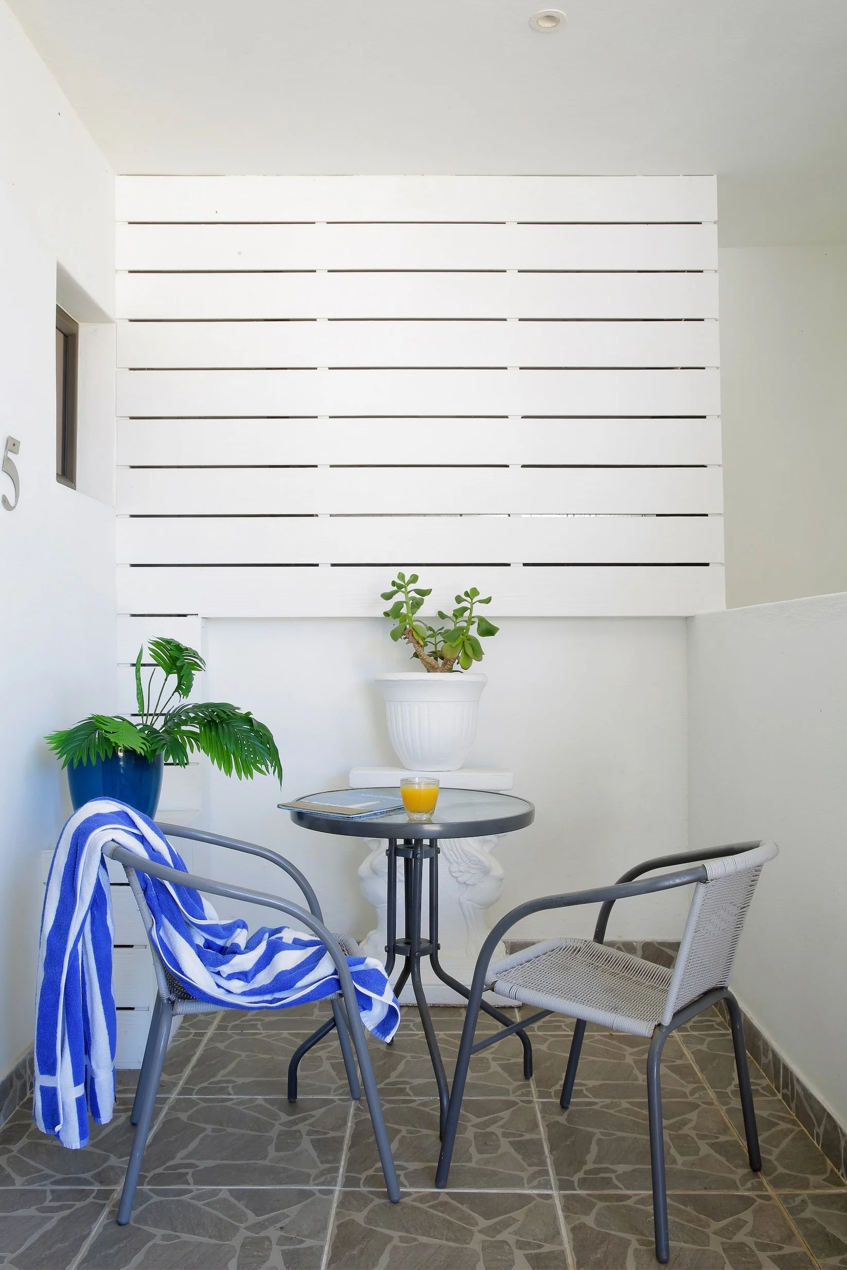 Private balcony seating area with outdoor table and chairs at Mykonos Luxury Guest House, St Francis Bay.