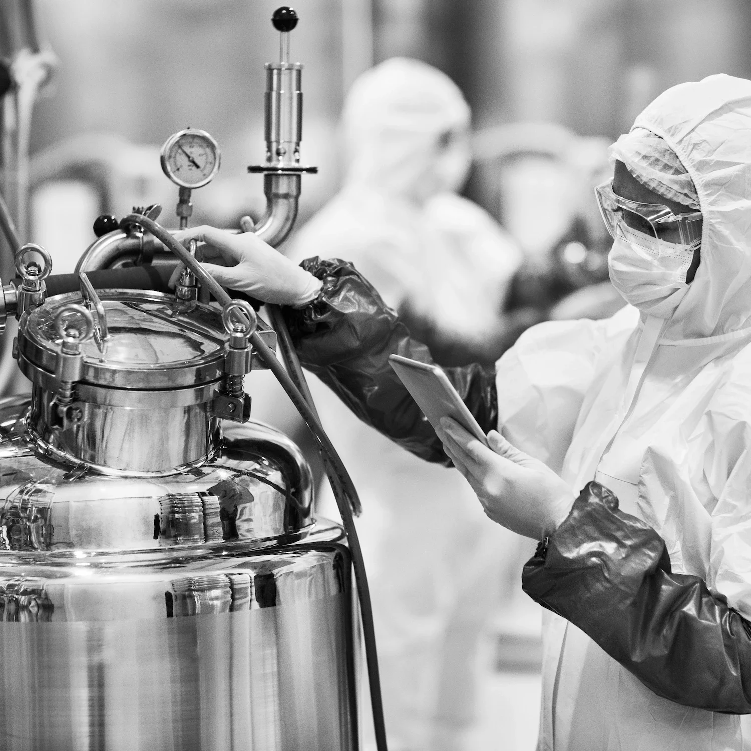 Pharmaceutical worker in cleanroom suit and mask representing leadership coaching in London