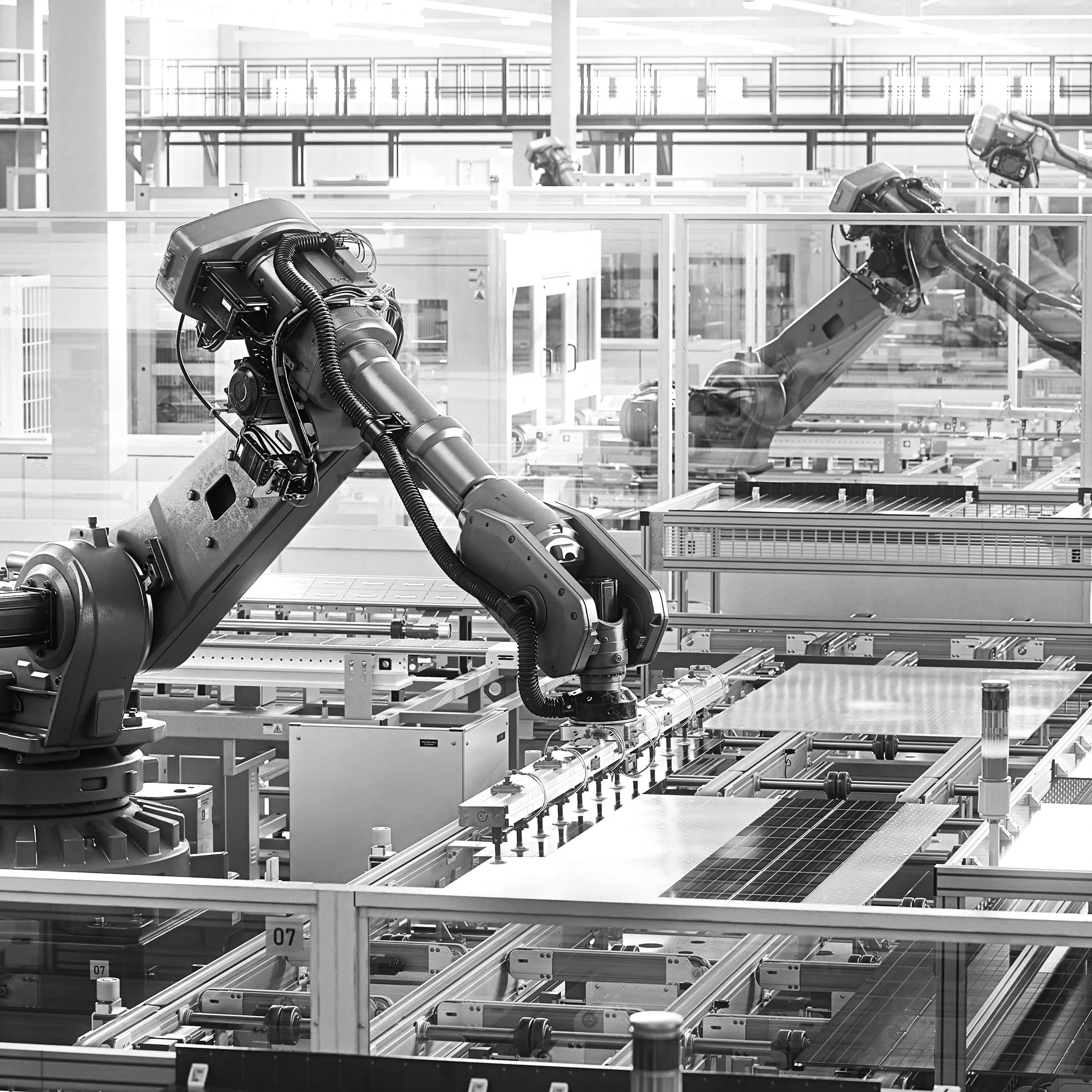 Automated robot arms on manufacturing production line representing London industry and leadership coaching