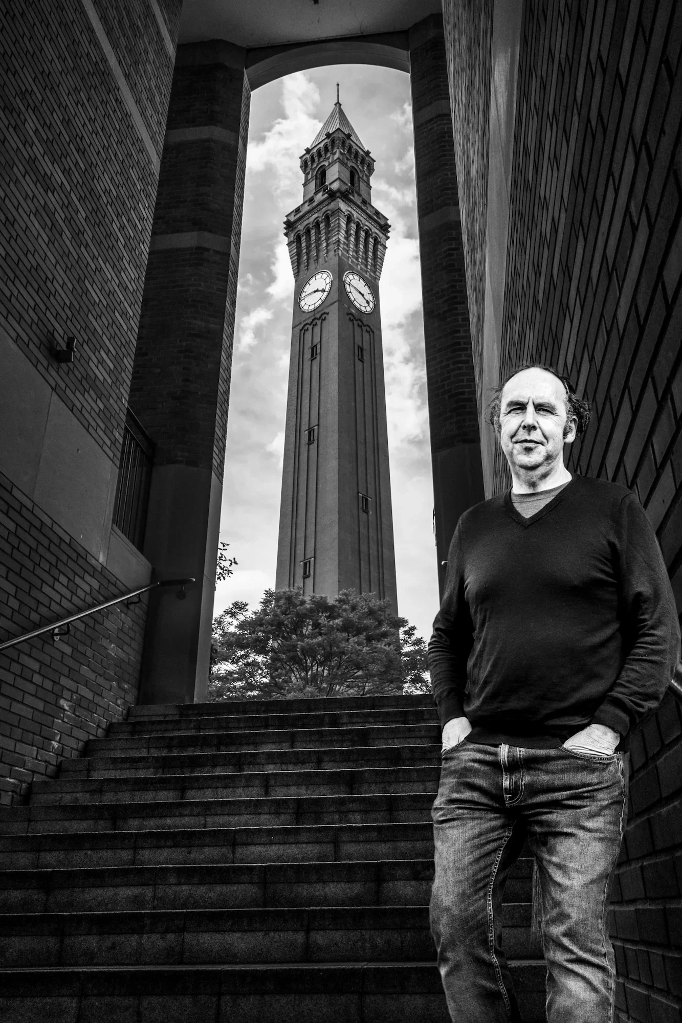 Professor John Dyson, executive coach, standing in front of the Joseph Chamberlain Memorial Clock Tower at the University of Birmingham
