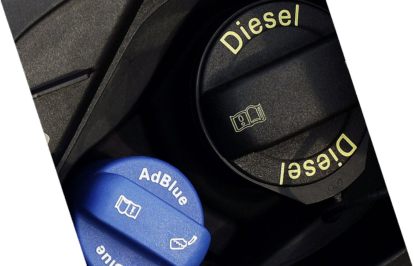 Close-up of car engine oil caps indicating diesel and AdBlue fluid reservoirs.