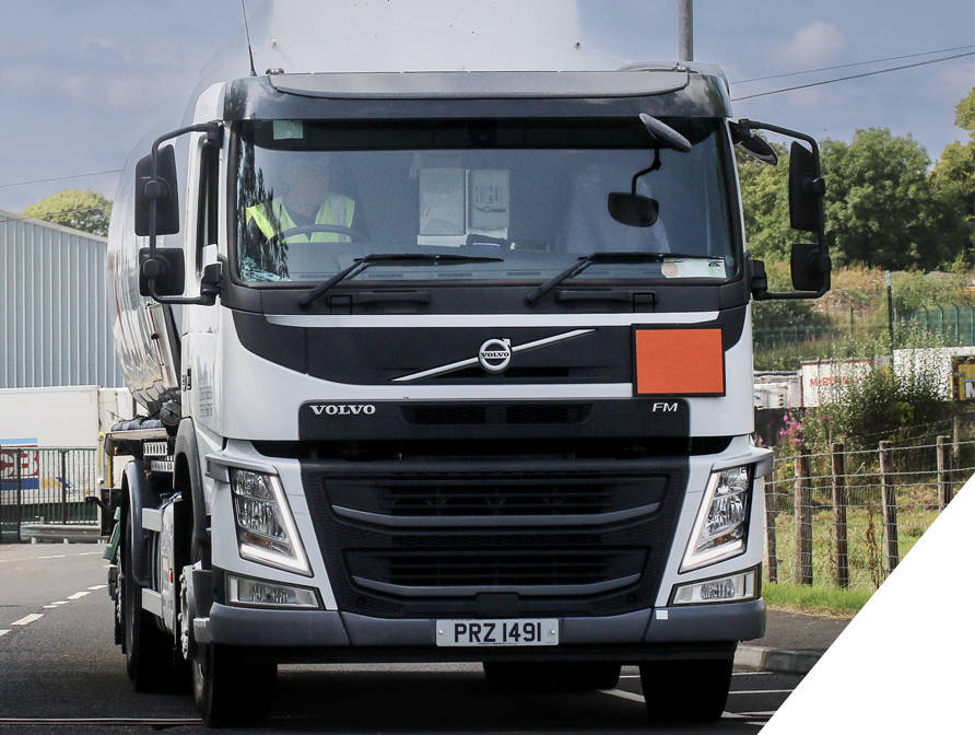 Front view of a white Volvo FM truck parked on a road.