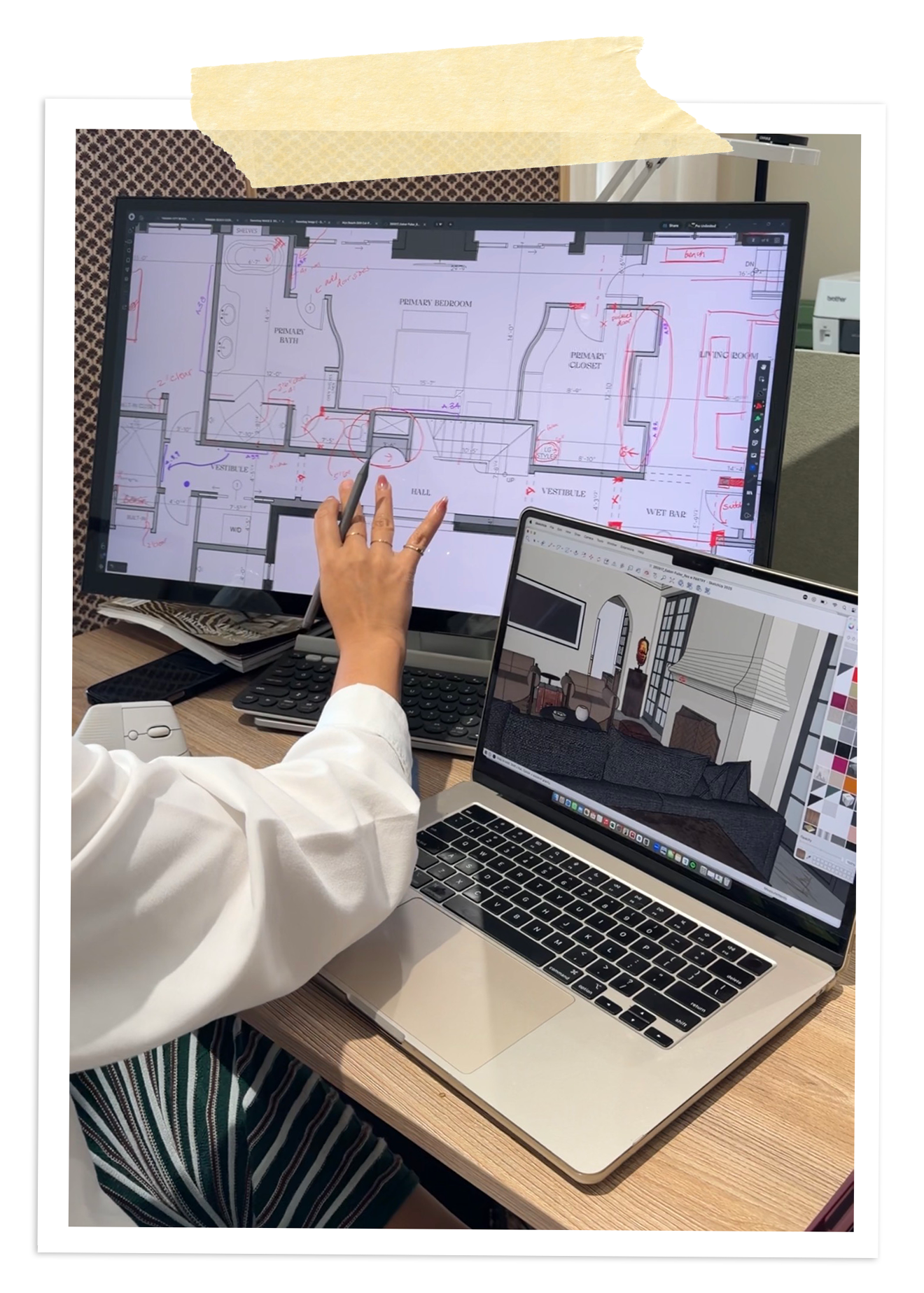 Reviewing a floor plan for construction documents on a monitor and laptop