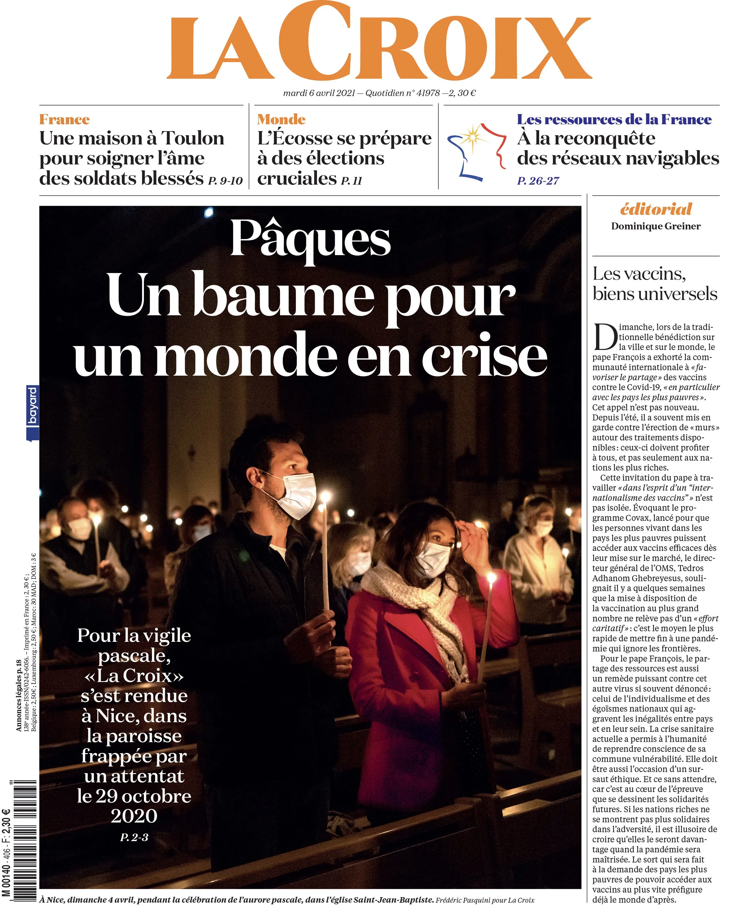 People holding candles during Easter vigil at church, wearing face masks, with article headline about a world in crisis.
