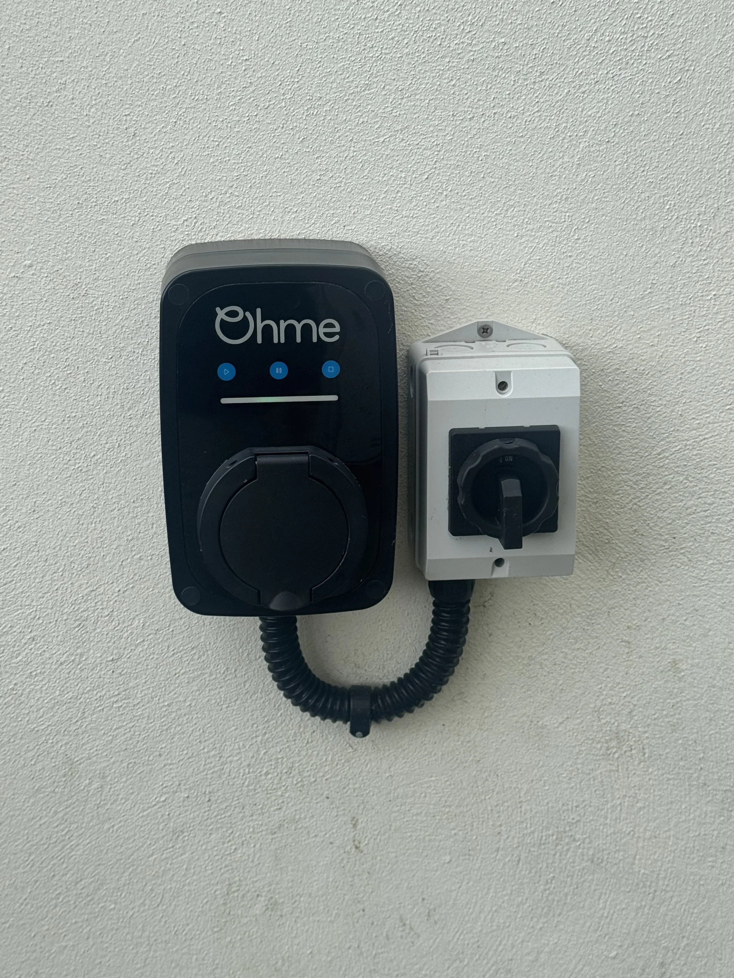 EV home charger and isolator switch on side of house, Non tethered cable