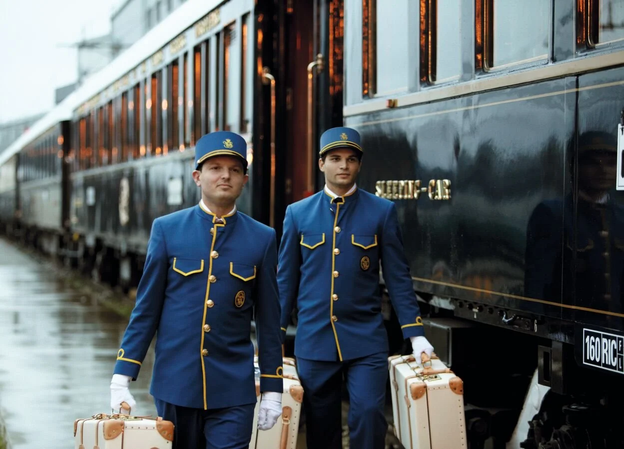 Bell Boys with luggage at the station of the Belmond Train