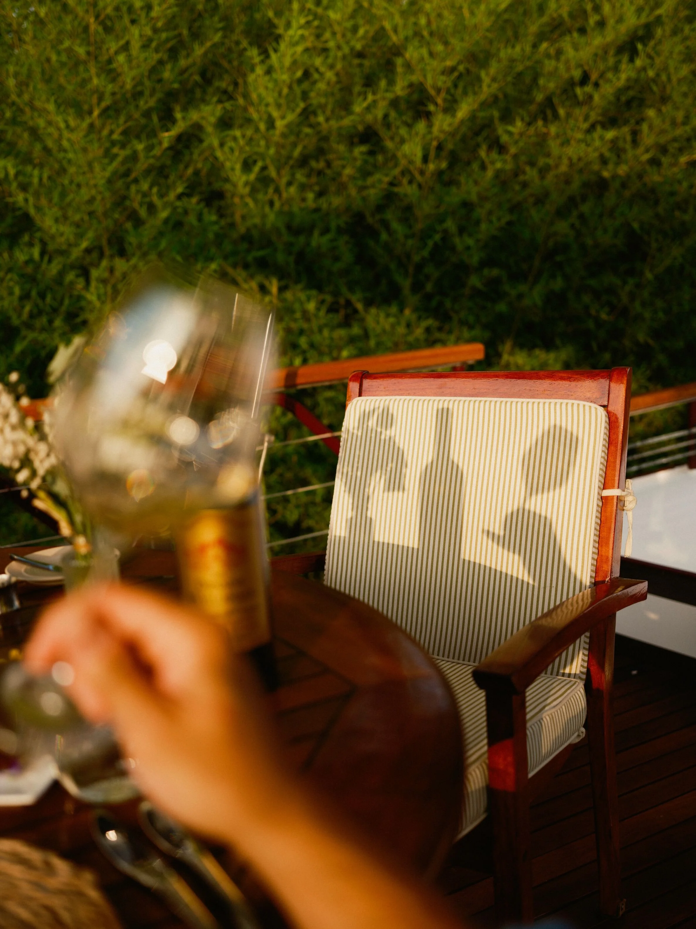A man enjoying a glass of burgundy red on a barge in France