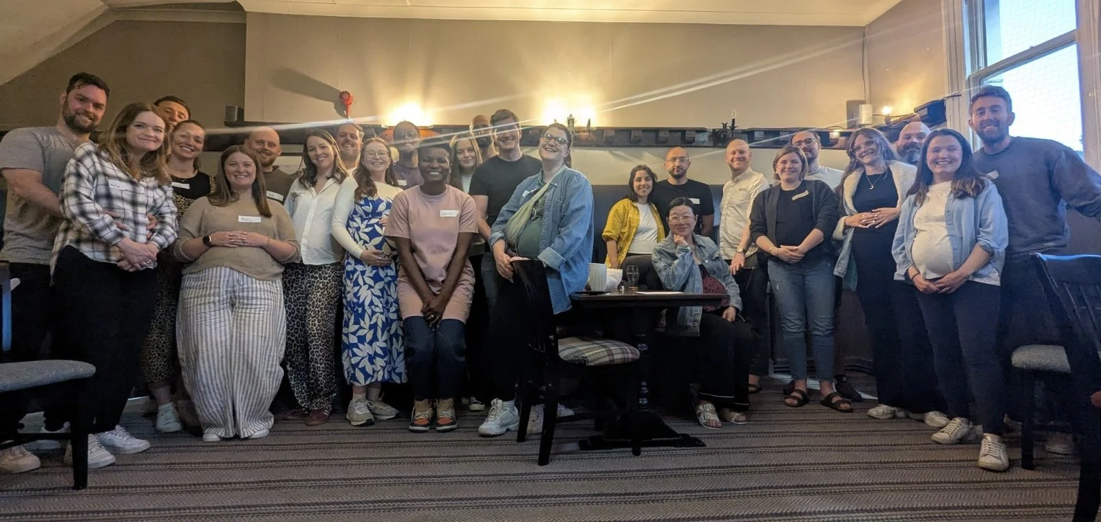 group of pregnant people smiling at the end of their antenatal course
