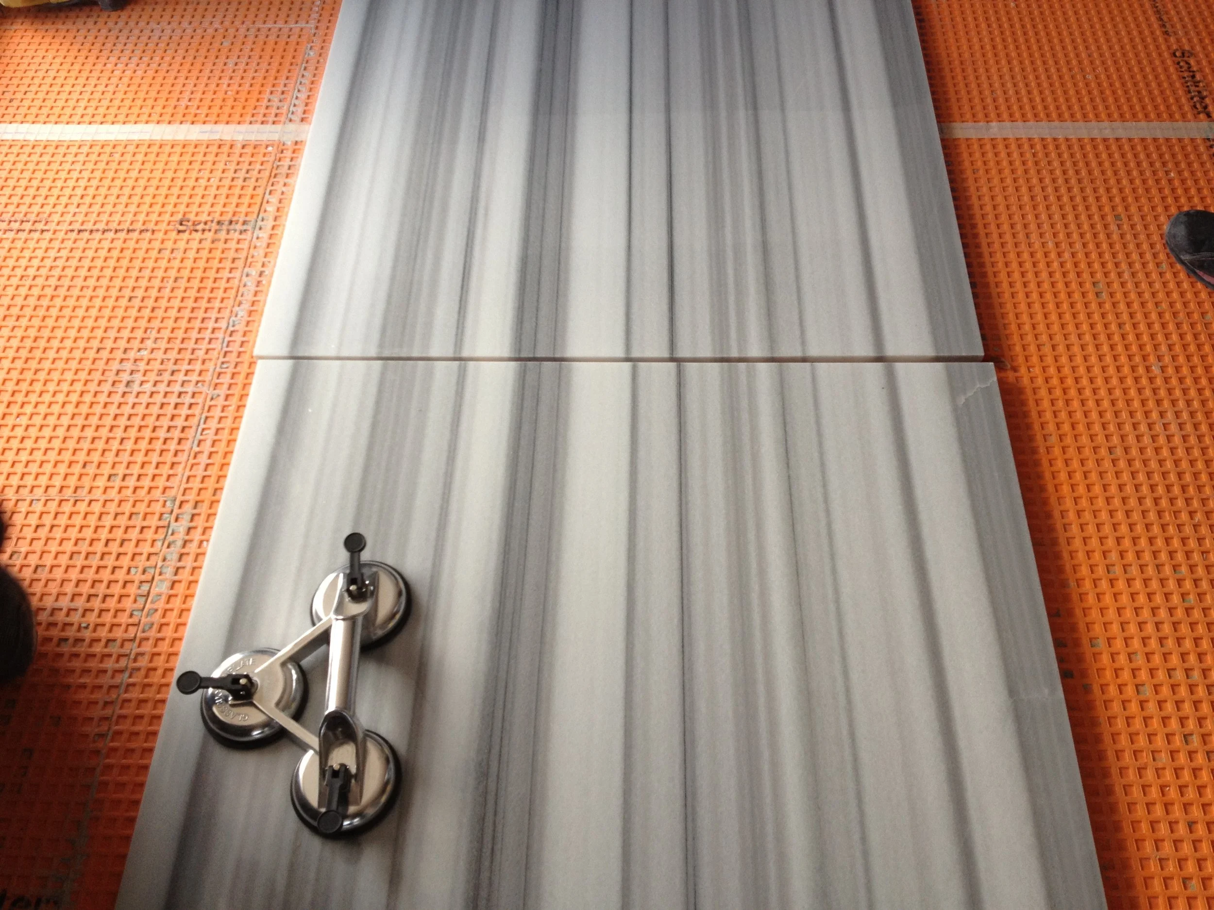 Striped marble slabs aligned for bookmatching during natural stone installation