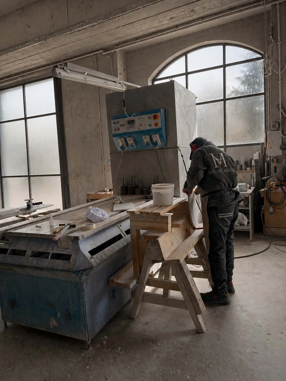 Stone finishing process in fabrication workshop as part of natural stone production