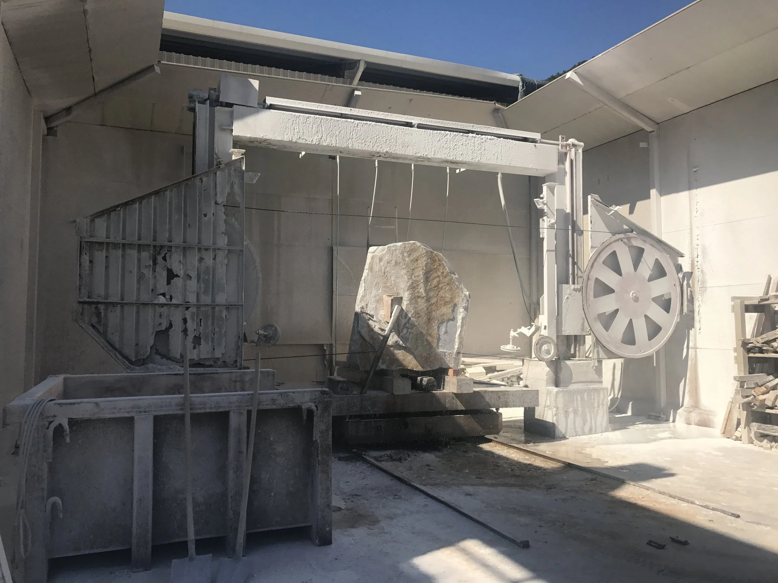 Stone block being cut during fabrication process in natural stone production