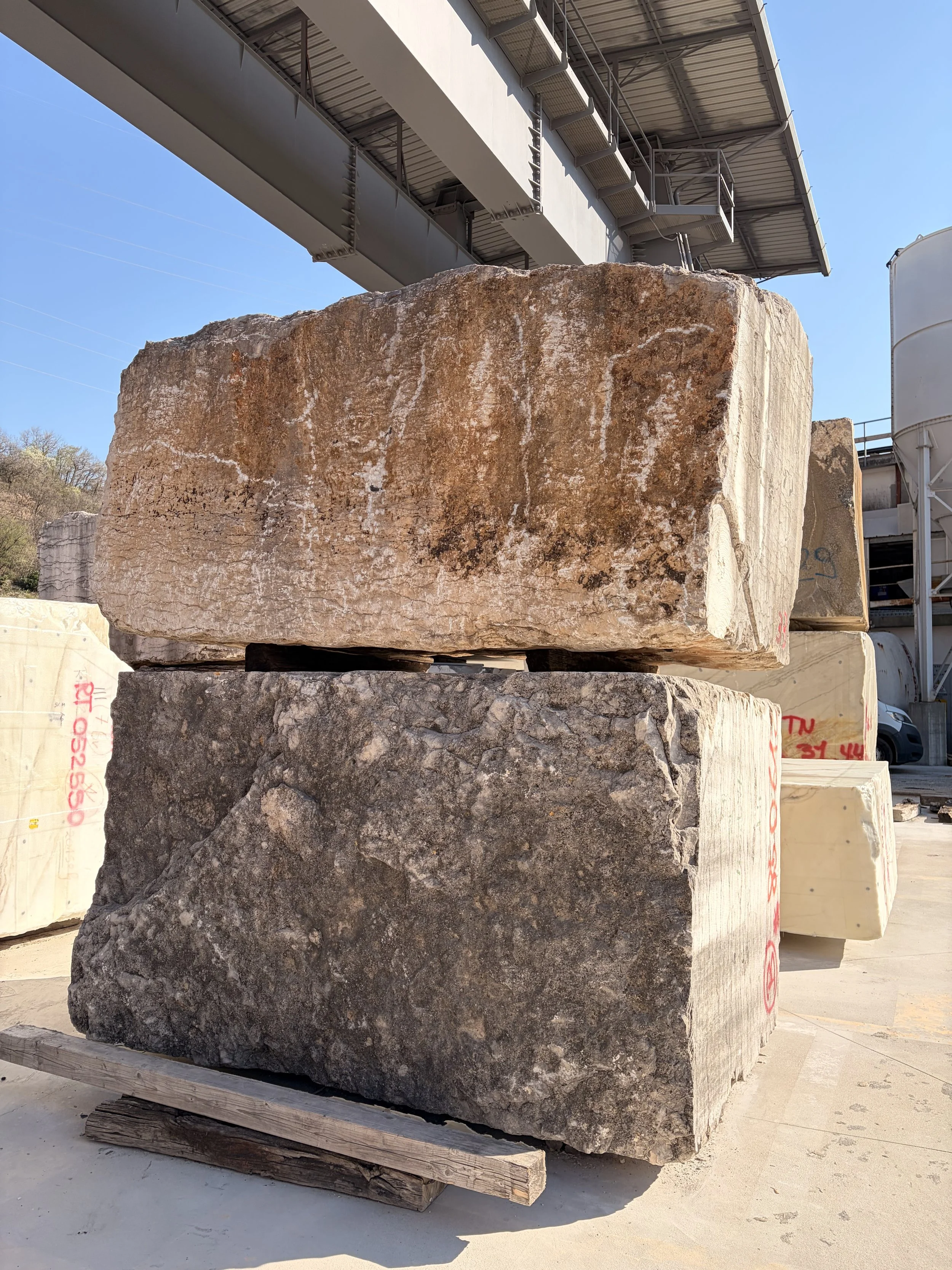 Natural stone blocks in quarry yard during sourcing and selection process