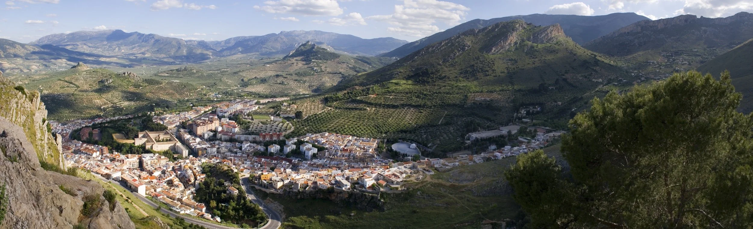 traditional white Andalucian village on a hillside seen from an aerial view