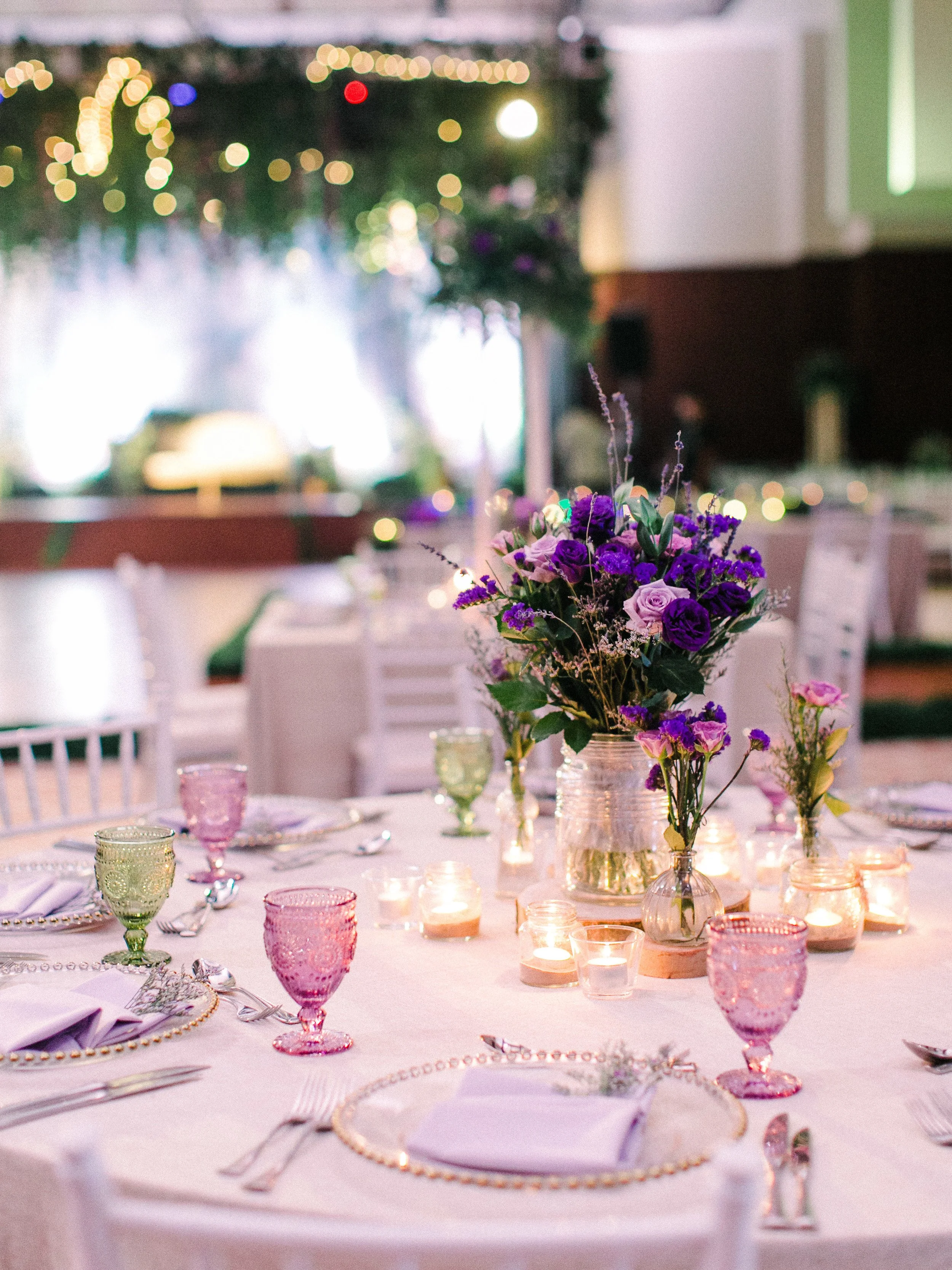 Elegant table setting with flower centerpiece and candles, for a special event or celebration.