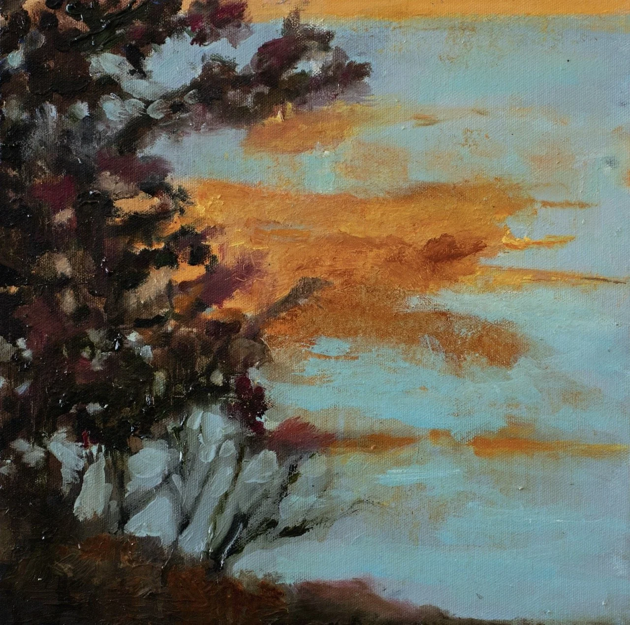 An impressionistic painting of a sunset over a body of water with a tree and bushes in the foreground.