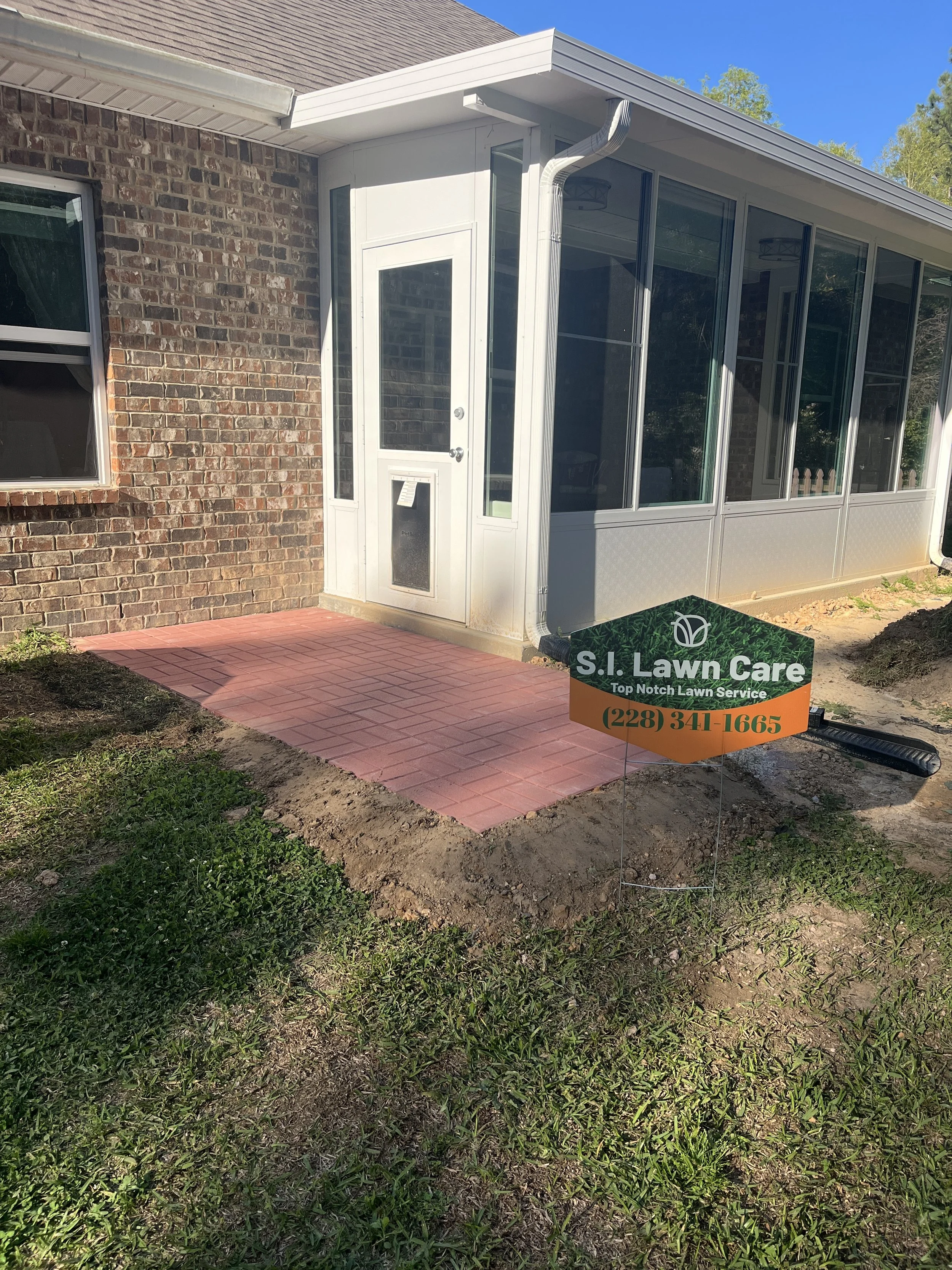 A new professionally installed paver patio at the back door of a house in Gulfport, Ms