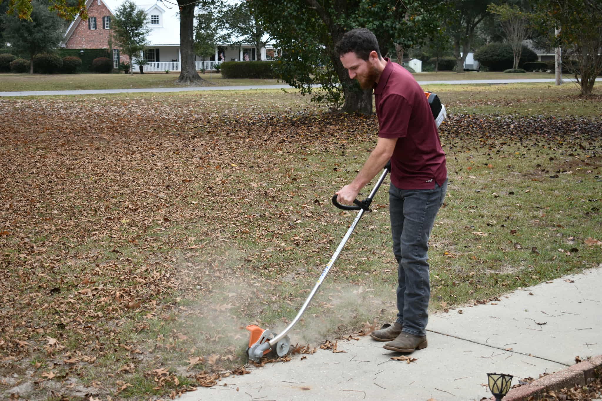 Expert lawn care crew edging and trimming a residential lawn