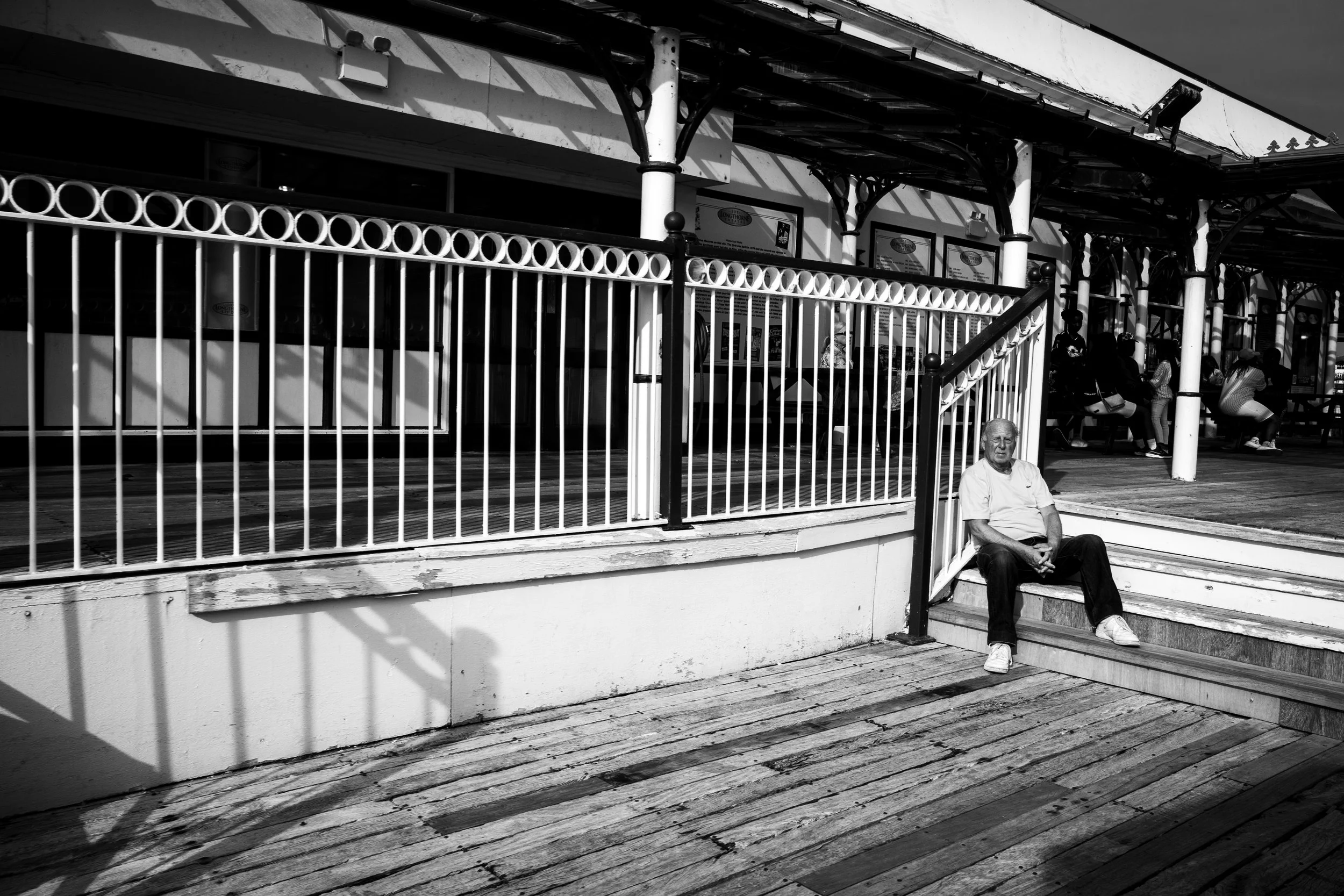 Man Sitting on Steps on the Pier.jpg