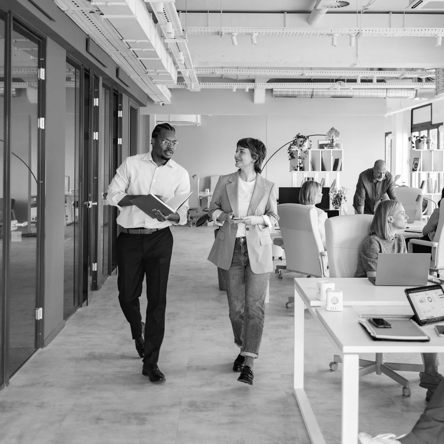 two business people walking through office