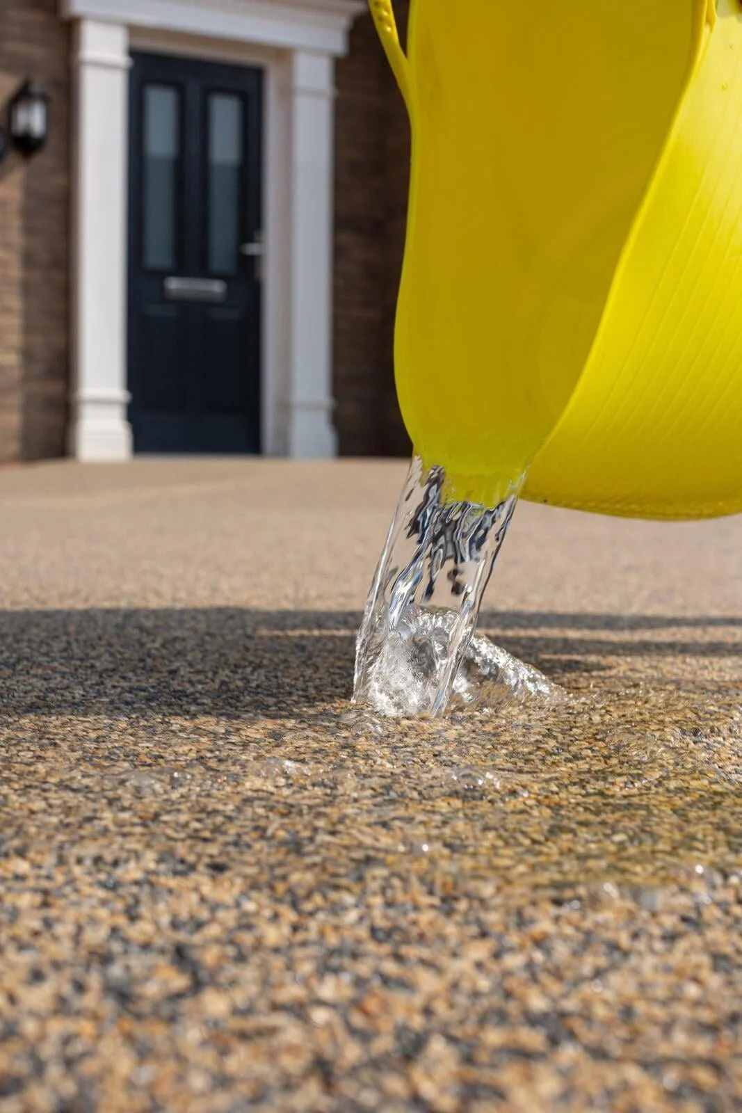 Water draining through permeable stone driveway surface