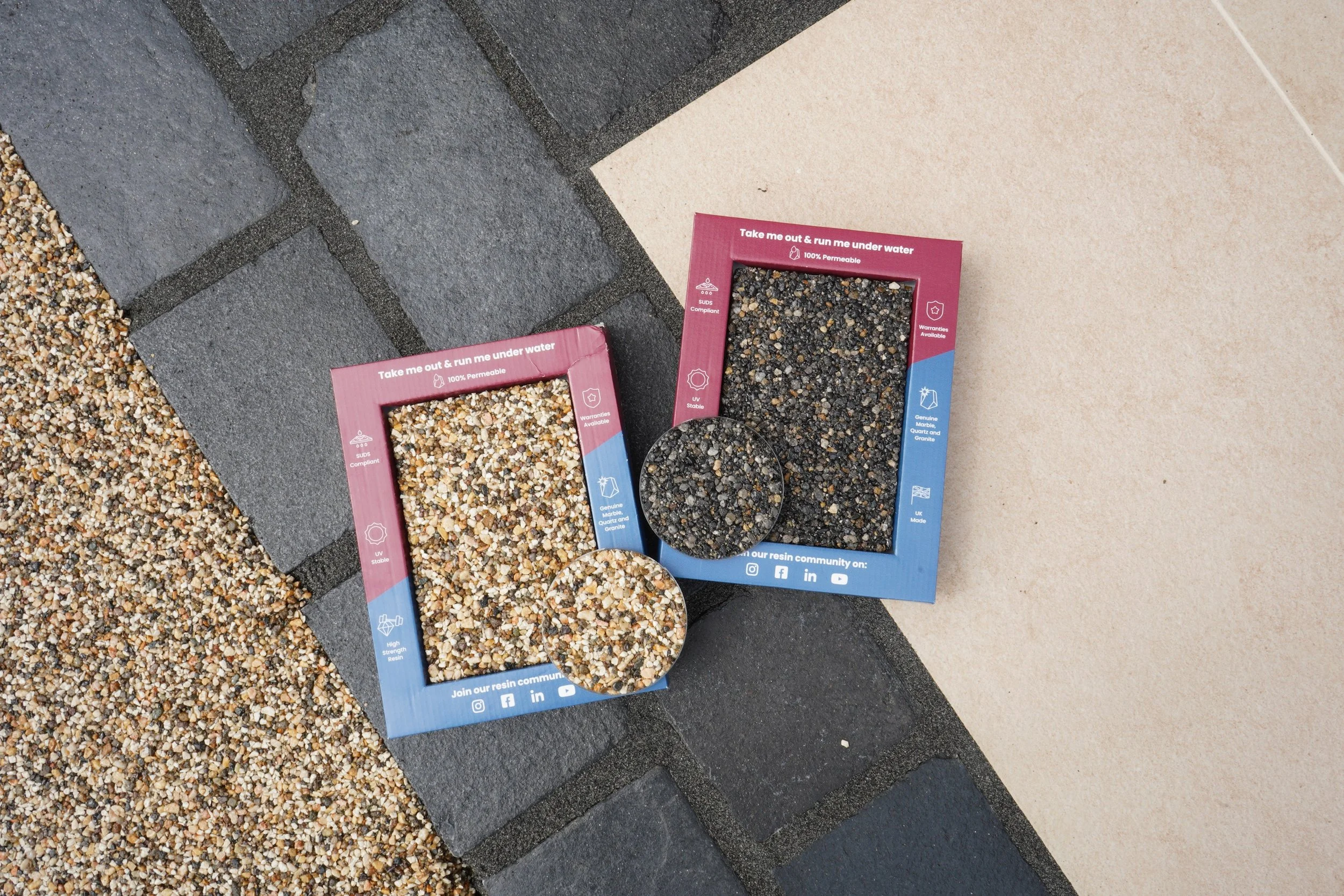 Stone color samples displayed on a driveway surface