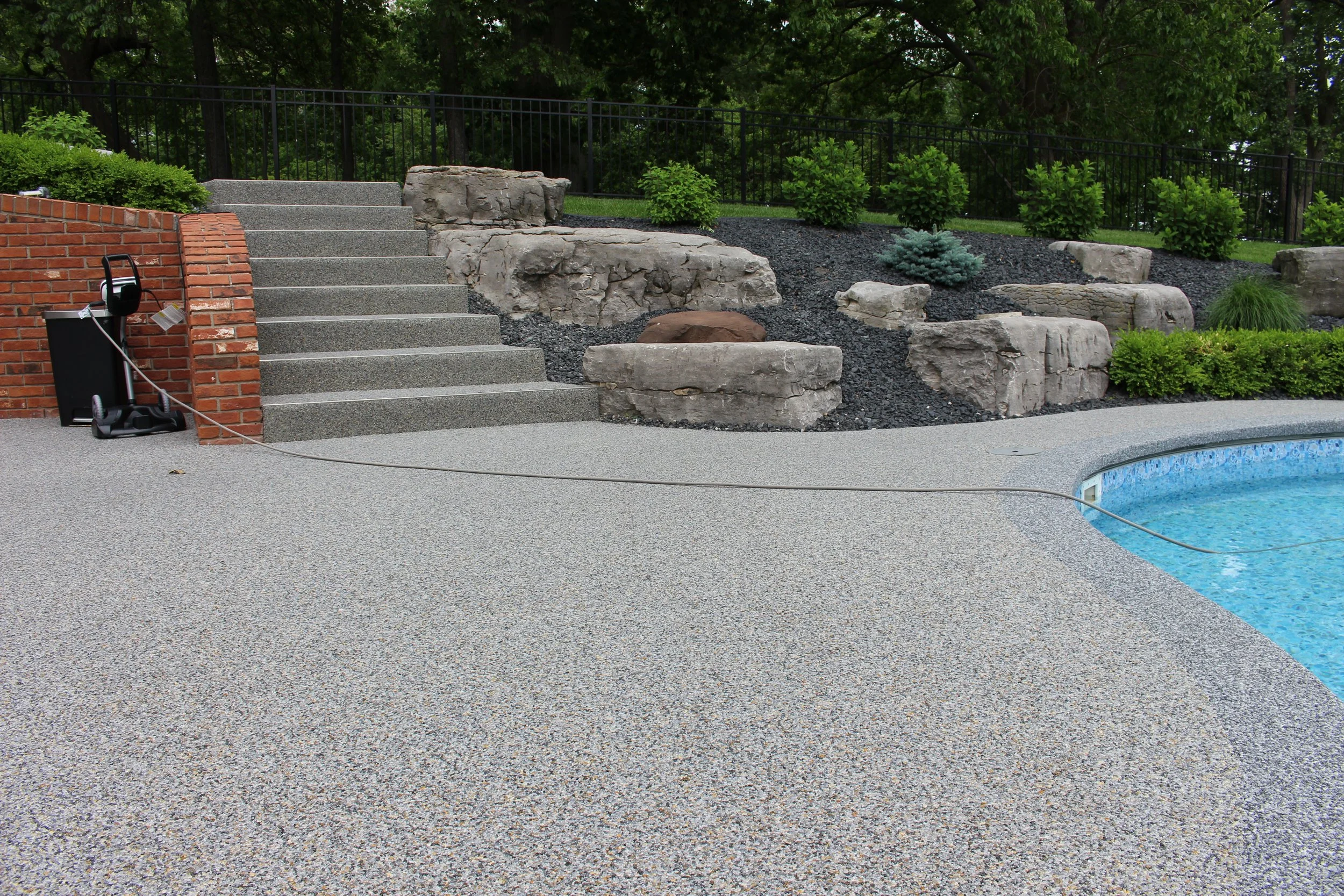Completed stone pool deck resurfacing with seamless non-slip finish