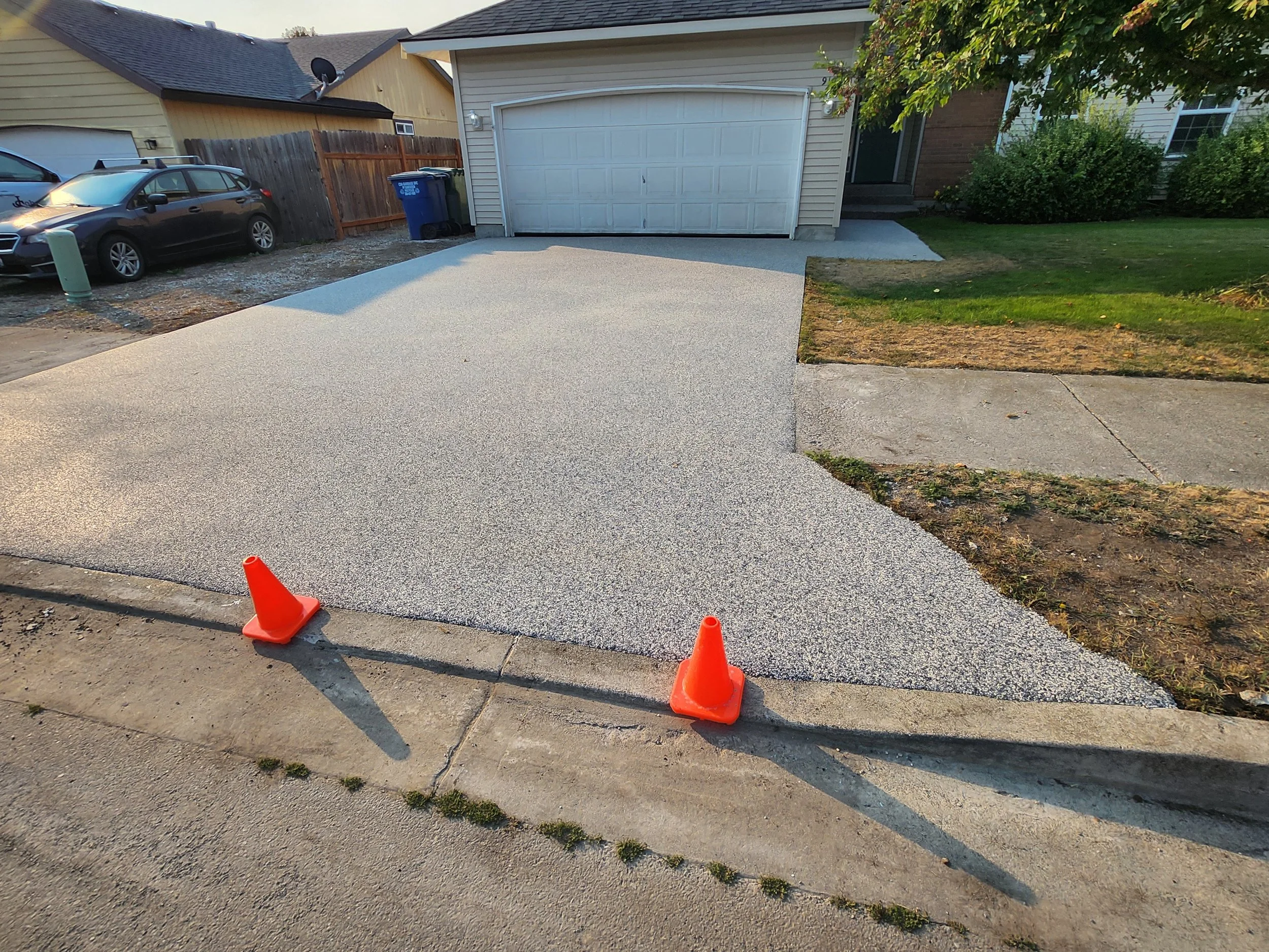 After: seamless stone driveway surface installed over existing concrete