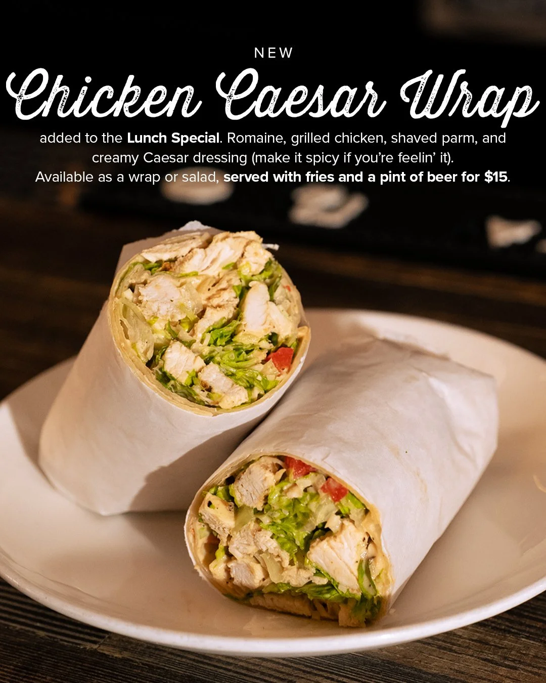 Plate with two chicken Caesar wraps, one cut in half to show lettuce, grilled chicken, and tomatoes inside.