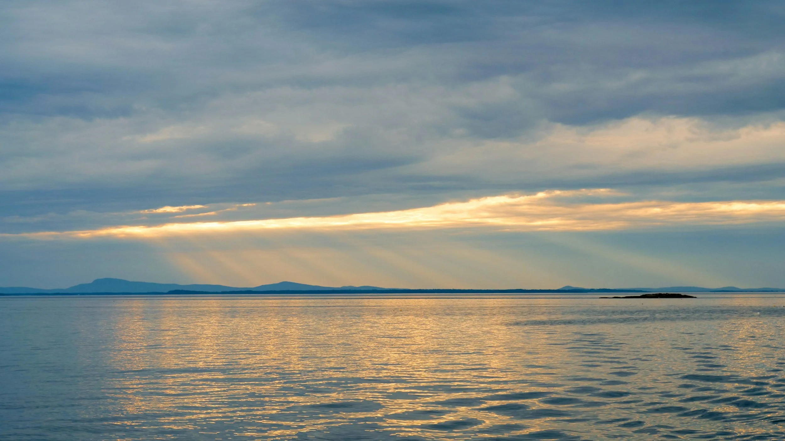 Maine coastline sunset representing clean air and water for Bangor-area businesses