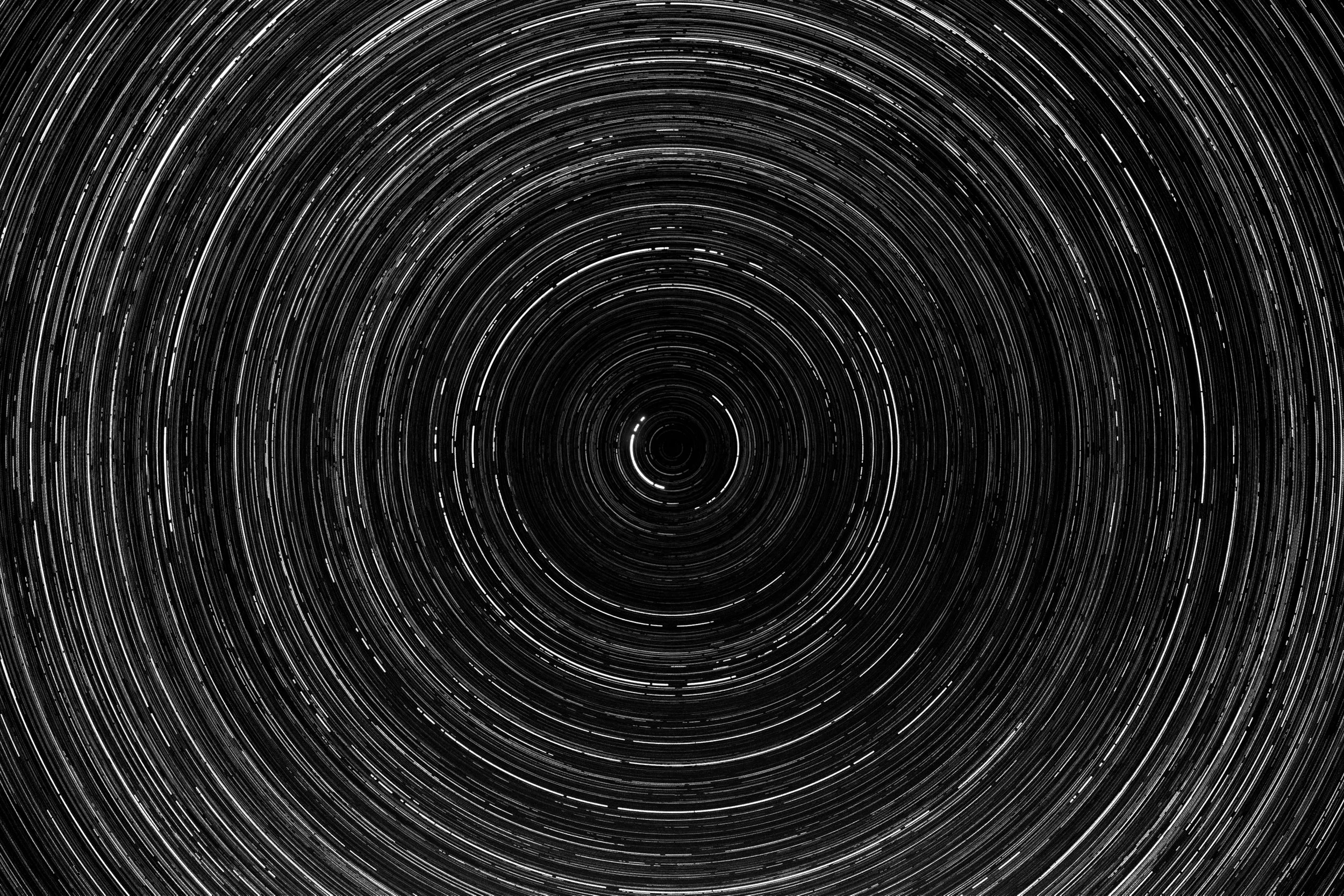 Long exposure photograph of star trails in the night sky forming concentric circles around the celestial pole.