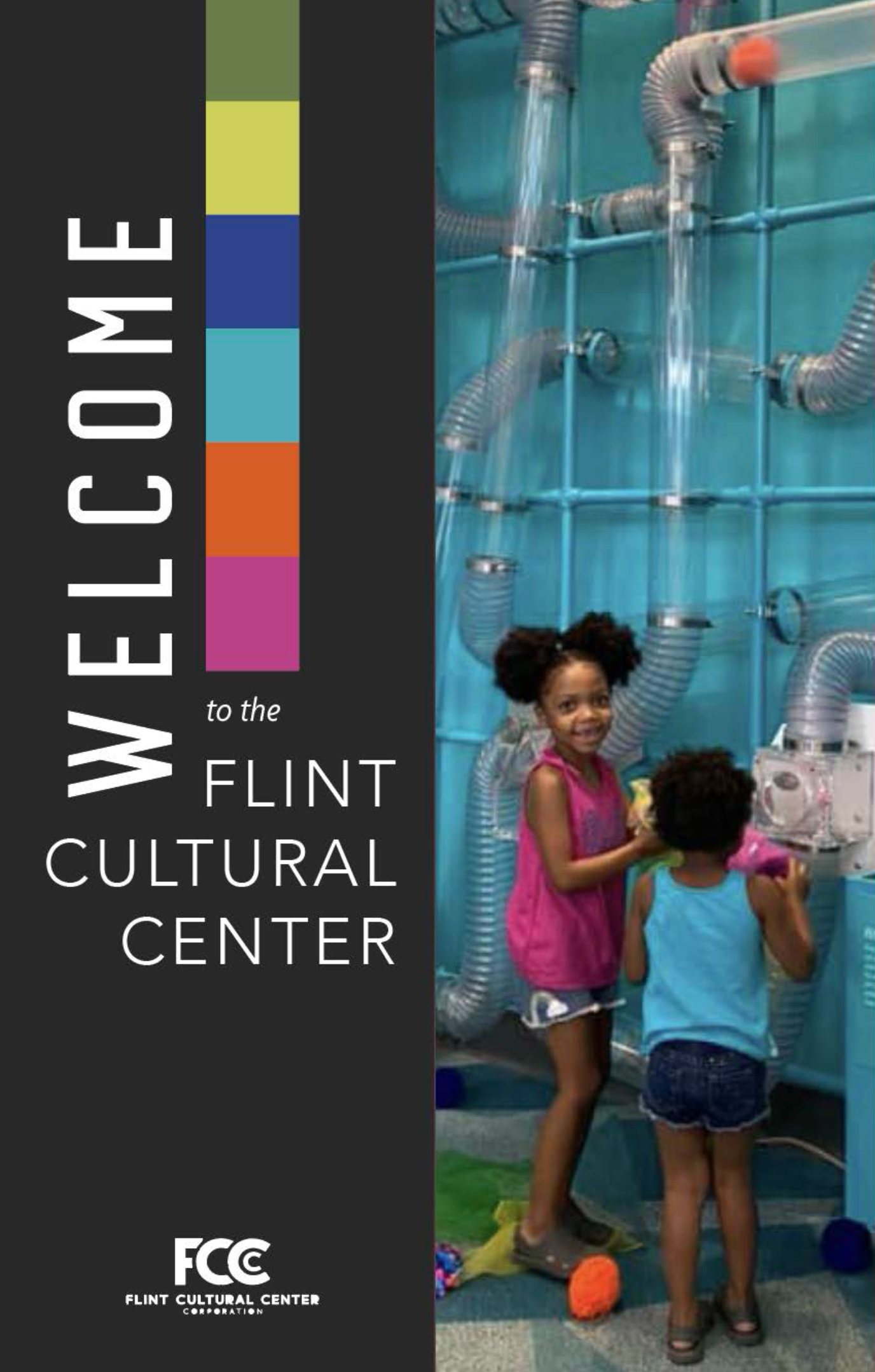 Children playing with pipes and hoses at the Flint Cultural Center, with a black and colorful informational banner on the left side of the image.