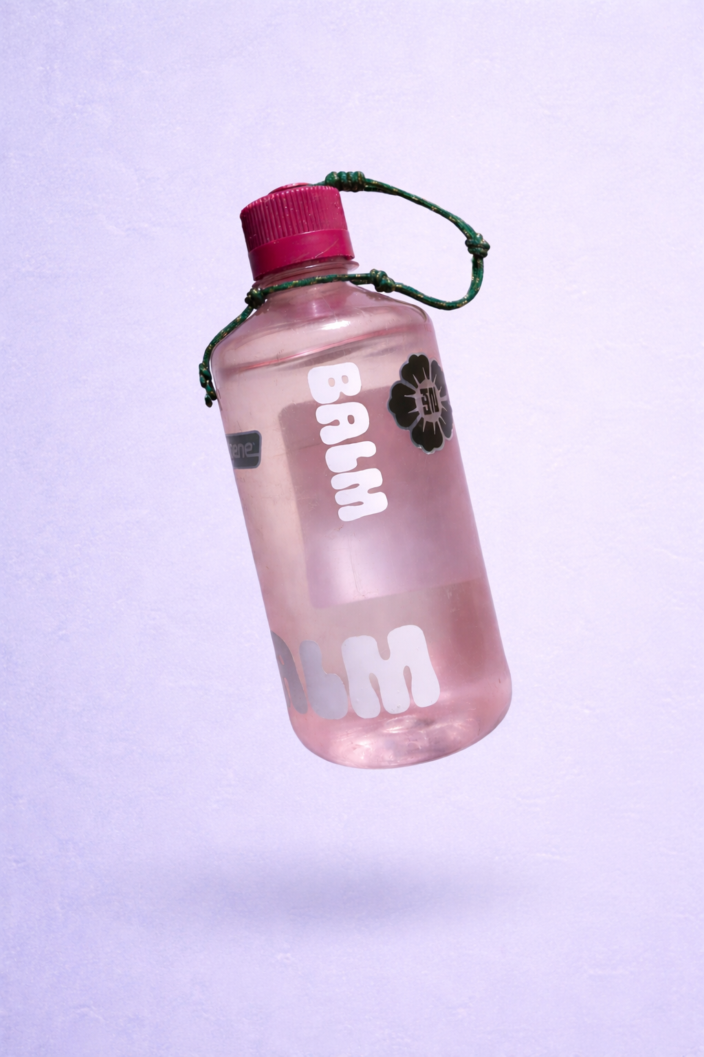 A pink translucent water bottle with a pink screw-on cap and a green cord. The bottle has white and black sticker decorations, including a black flower with red and white inside.