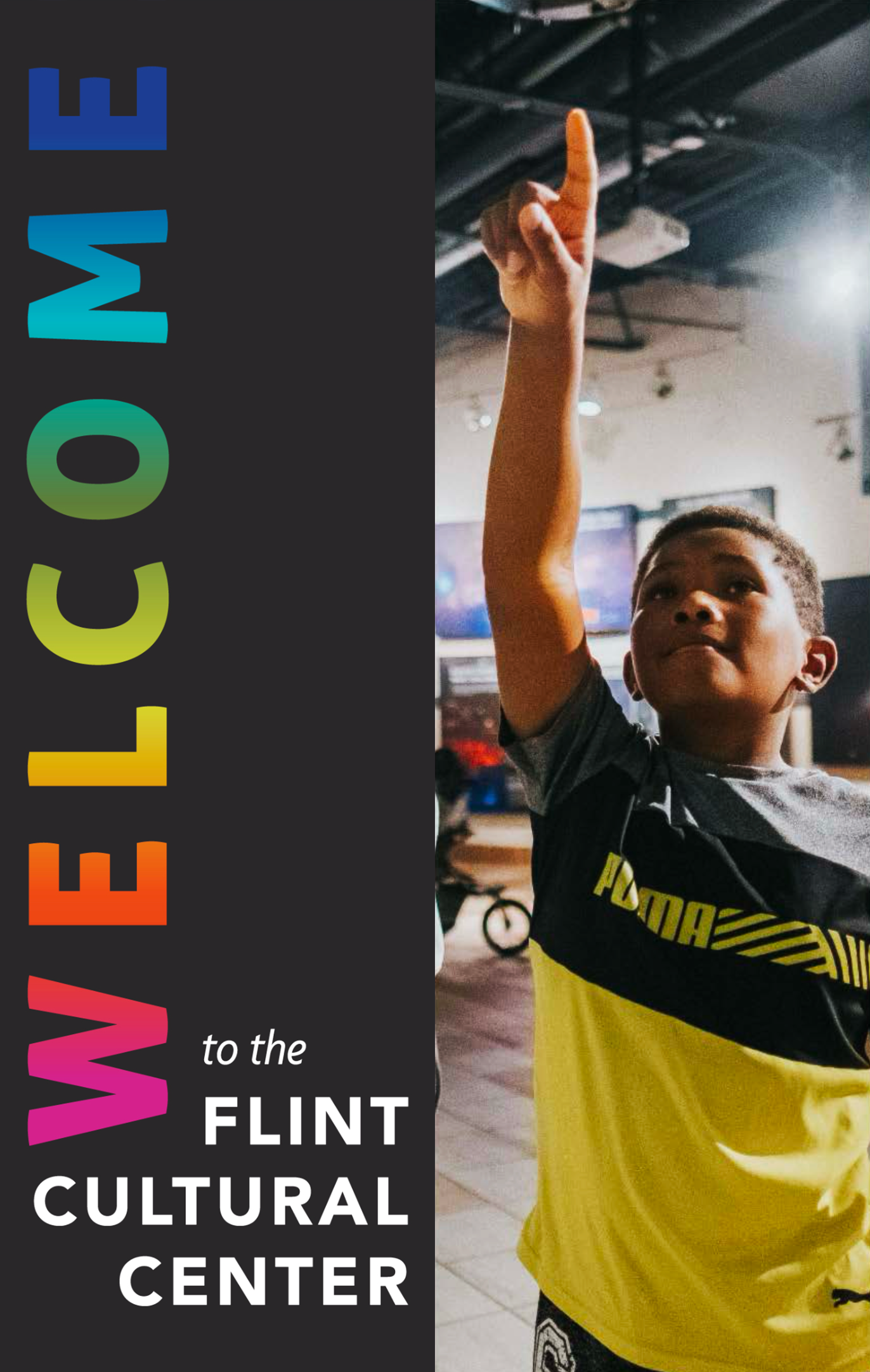 'Welcome to the Flint Cultural Center' written in colorful text on a black background, with a young boy pointing upward and wearing a black and yellow sports shirt.