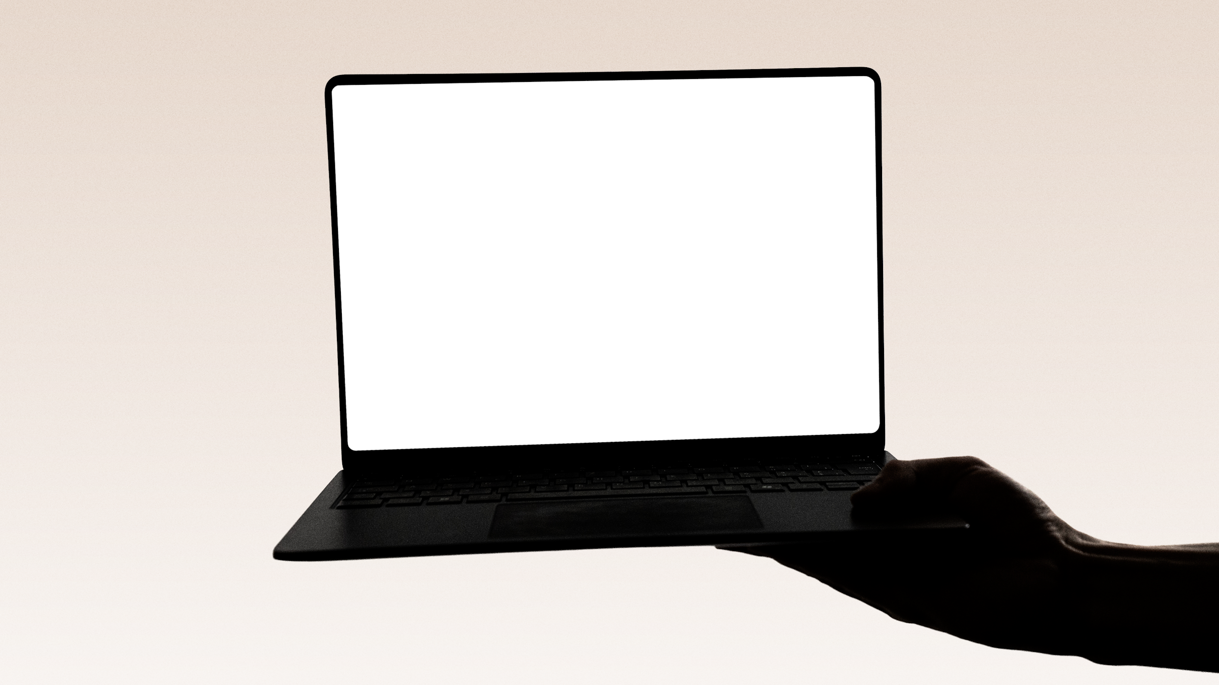A person holding a laptop with a blank white screen against a plain, light-colored background.