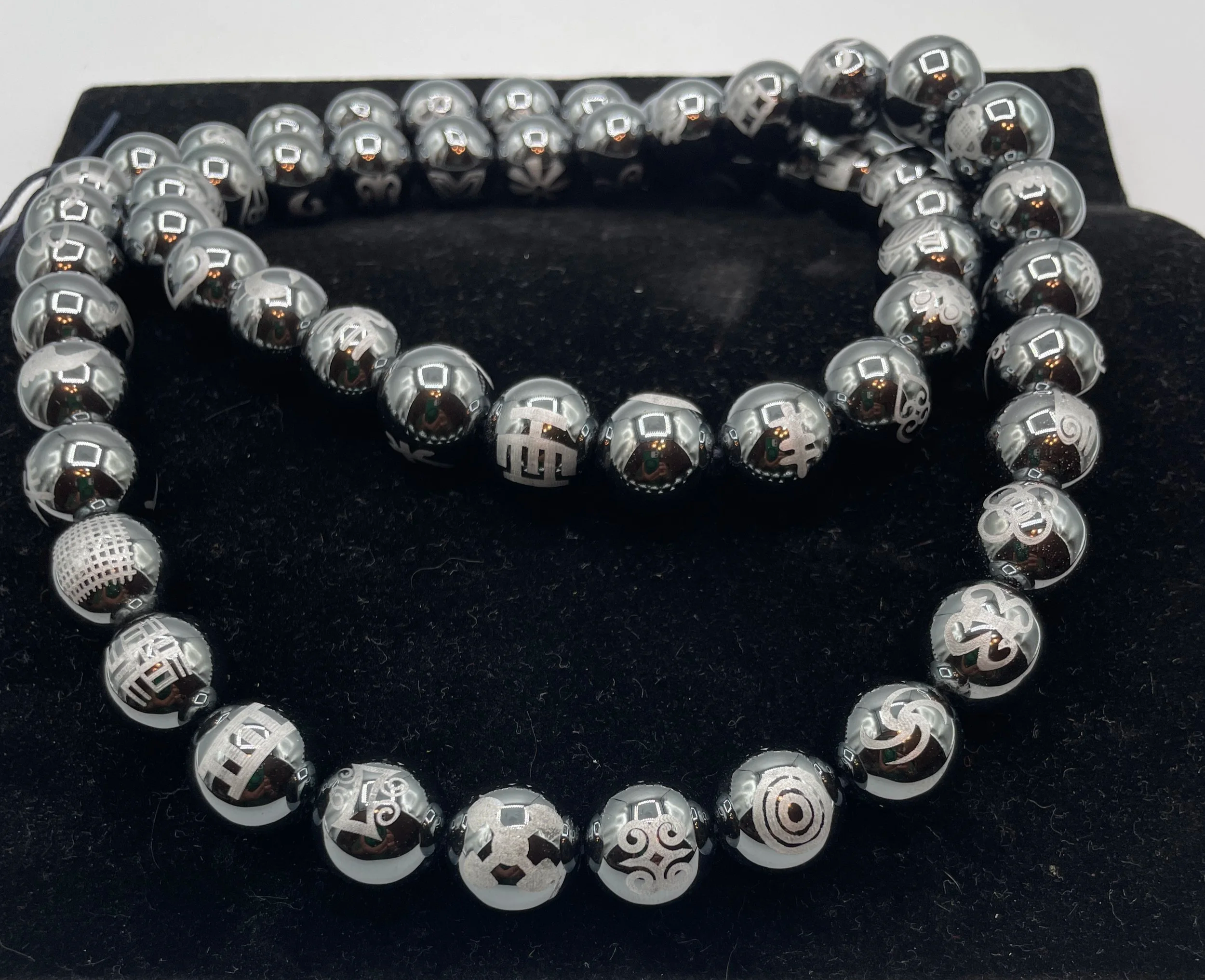 The Legacy in Stone Necklace
•	Specialty and Adinkra Collection
•	Laser engraved plated hematite beading
