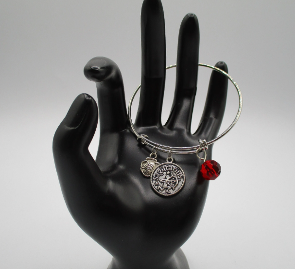Sagittarius the Optimistic in Red Bangle 1.png