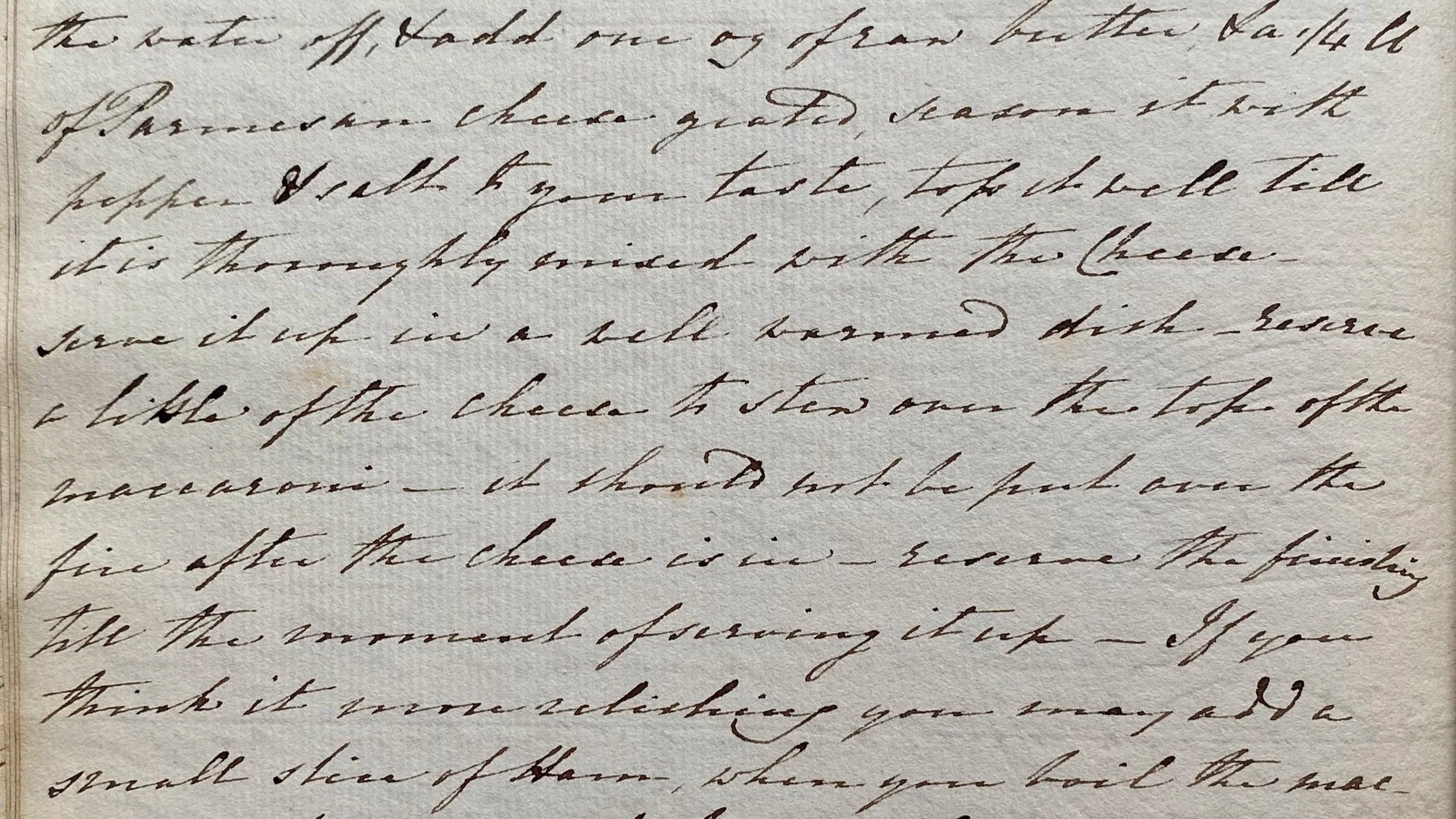 Close-up of handwritten cursive text on paper, describing a recipe.