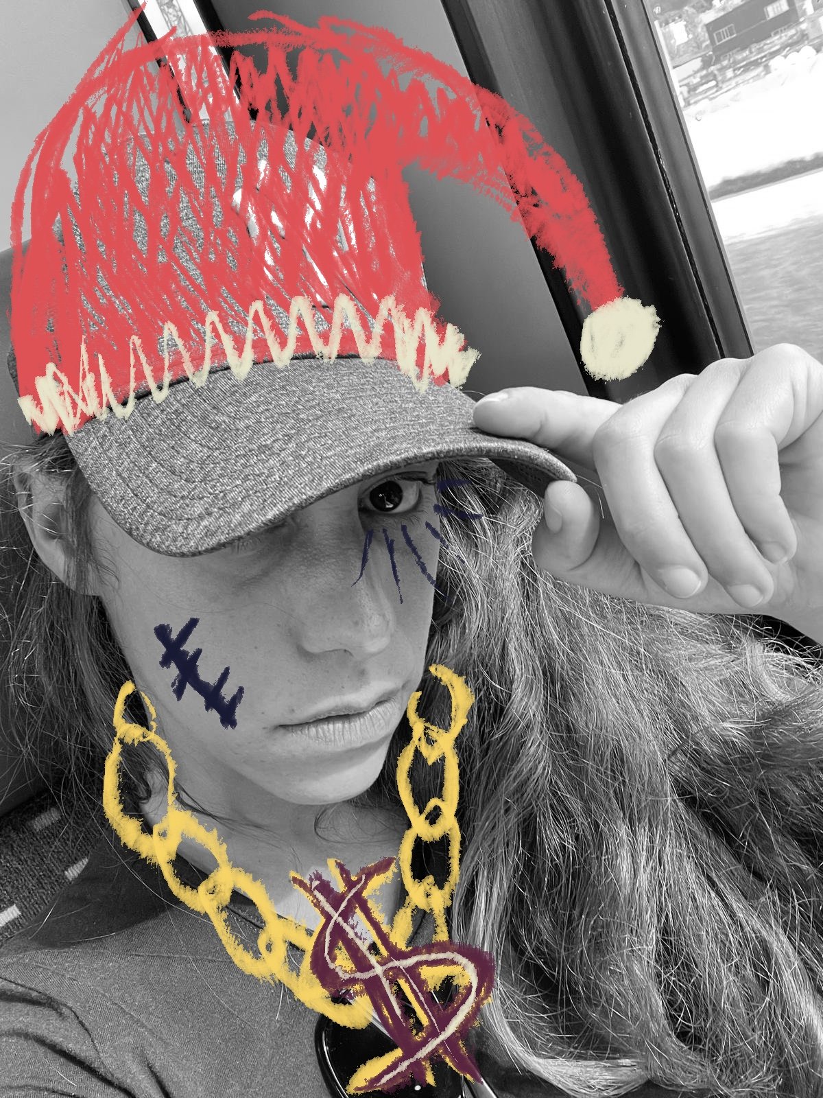 A person with long hair, wearing a gray baseball cap, holding the brim with one hand, with colorful doodles drawn over the black-and-white photo. The doodles include a red mustache, yellow chain necklace with a dollar sign pendant, and various marks on their face.