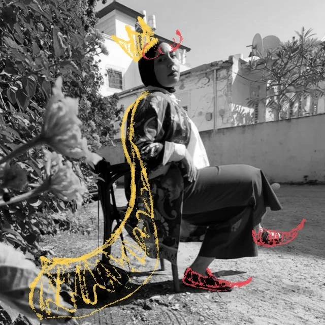 A woman sitting on a chair outdoors surrounded by plants and a concrete wall, wearing a patterned jacket, wide-leg pants, and flamboyant red shoes, in a black and white photo with digital yellow and red doodle accents.
