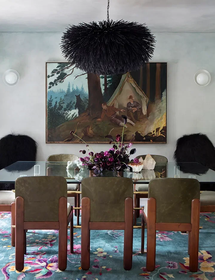 Anchored by expressive artwork and a sculptural chandelier, the dining space is designed to feel intimate yet impactful. Rich textures, tonal contrasts, and thoughtful symmetry create a setting where conversation, art, and atmosphere converge.