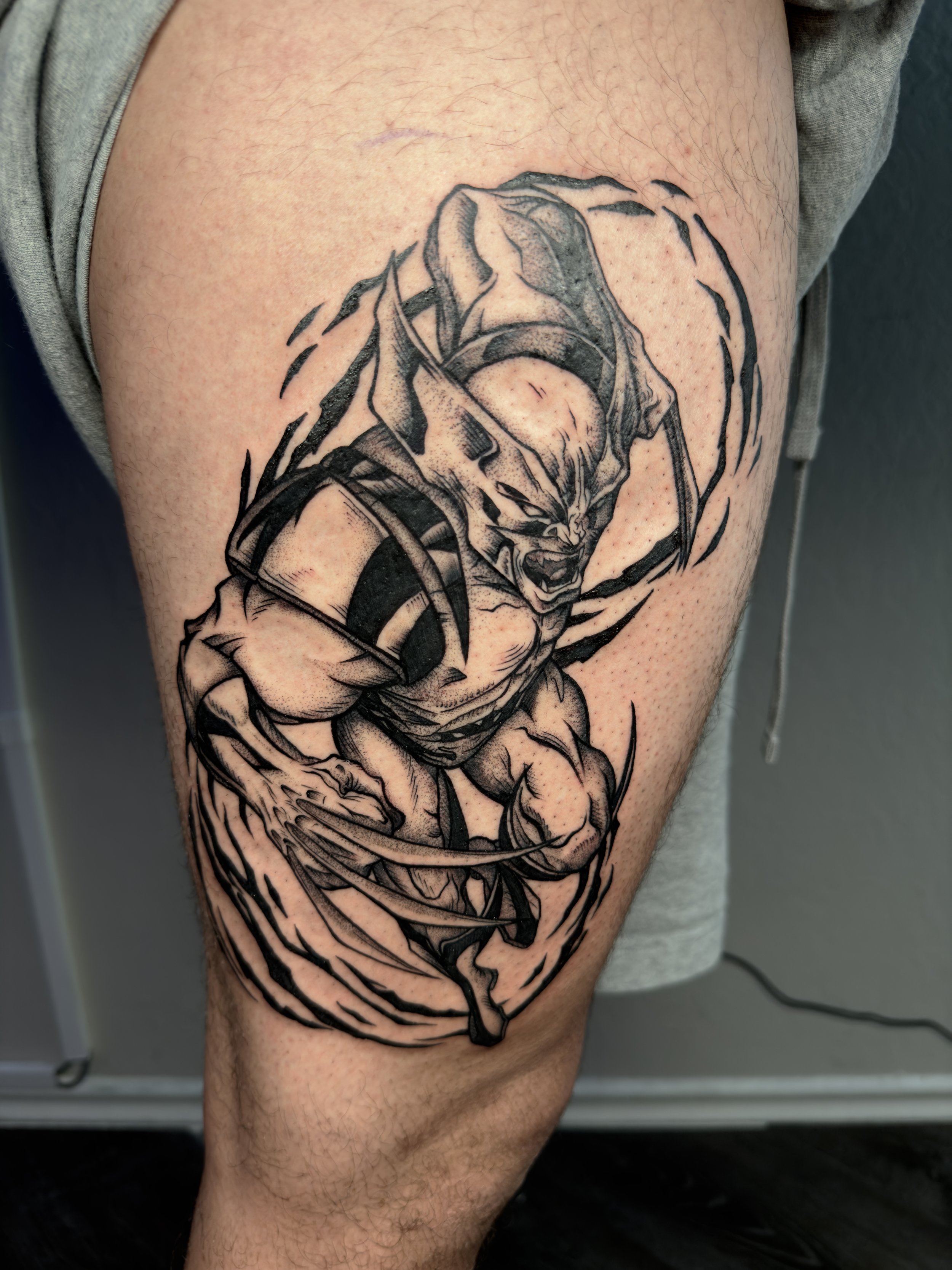 Black and gray tattoo of a fierce, snarling animal that appears to be a wolf or dog, with muscular limbs, surrounded by dynamic, swirling lines on person's thigh.