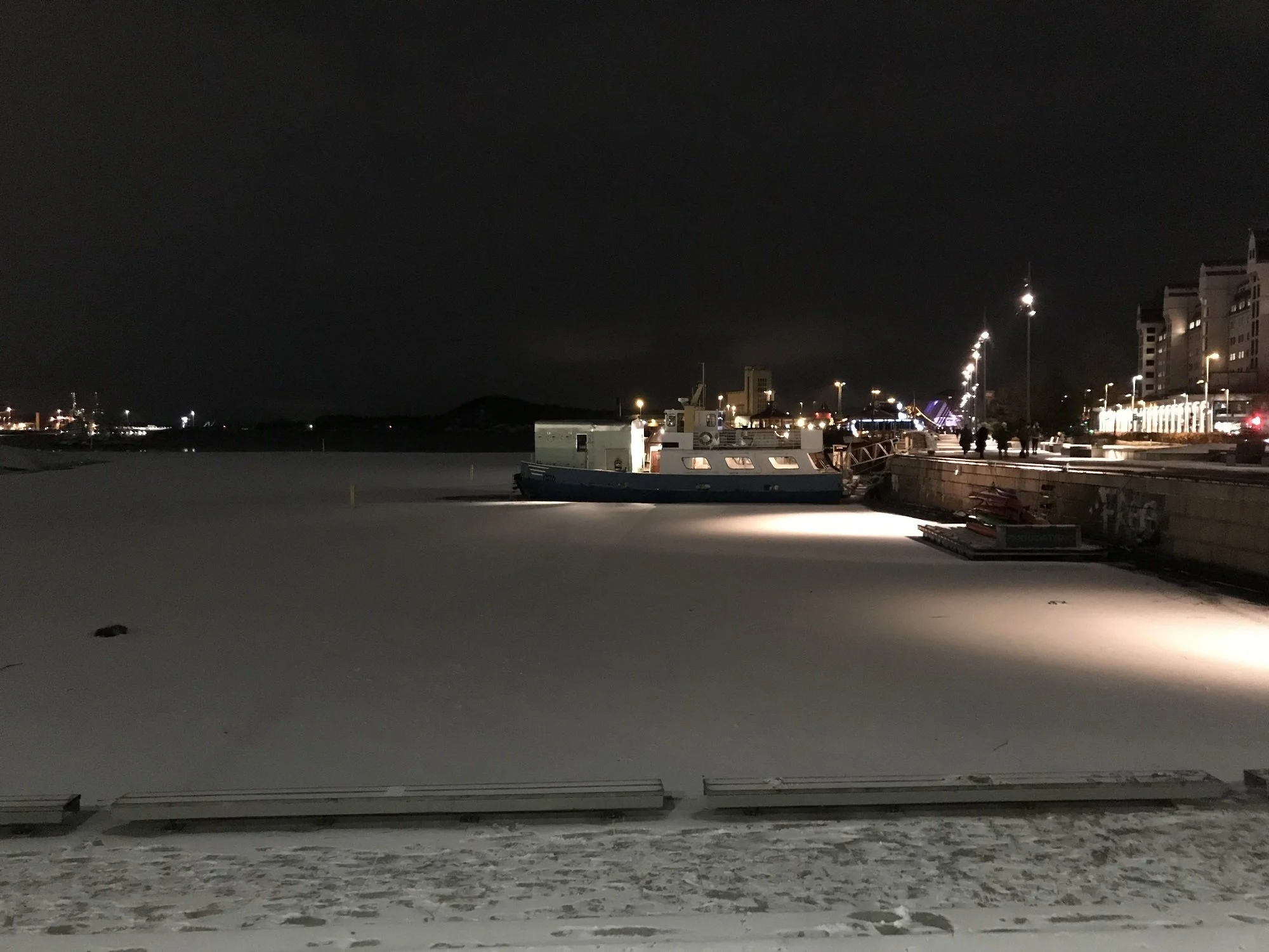 Frozen harbor with boat in Norway