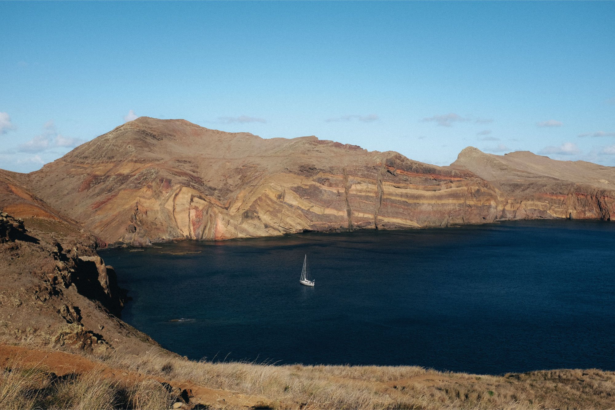 Coastal landscape with sailboat in Madeira