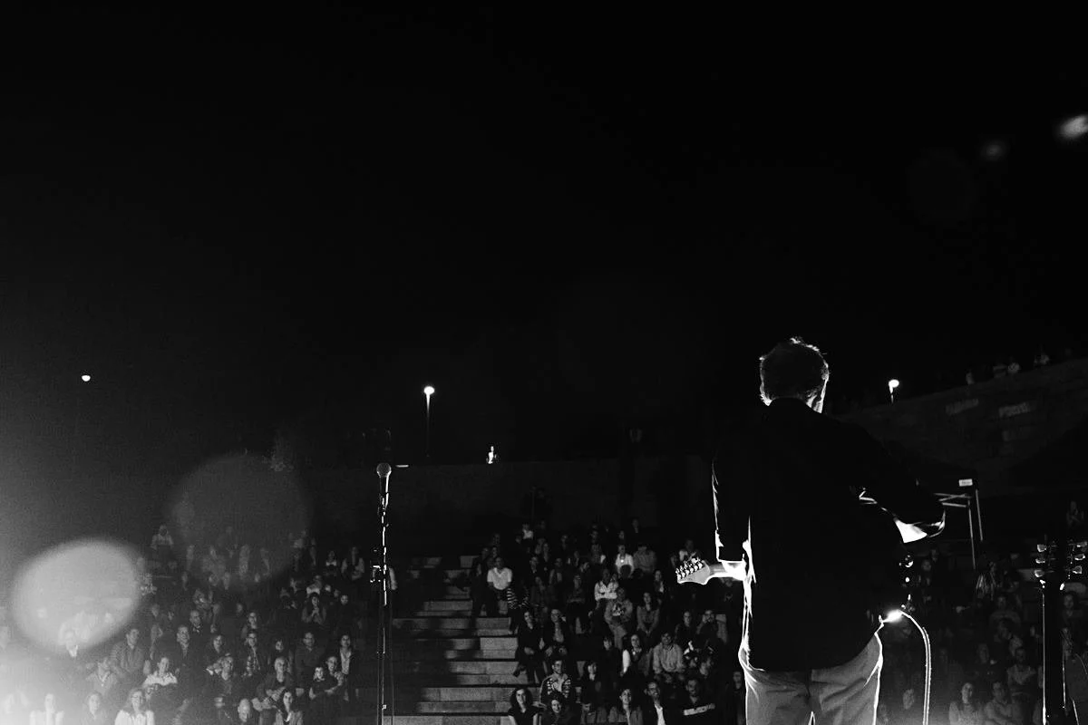 Sandy Kilpatrick performing on stage with audience watching