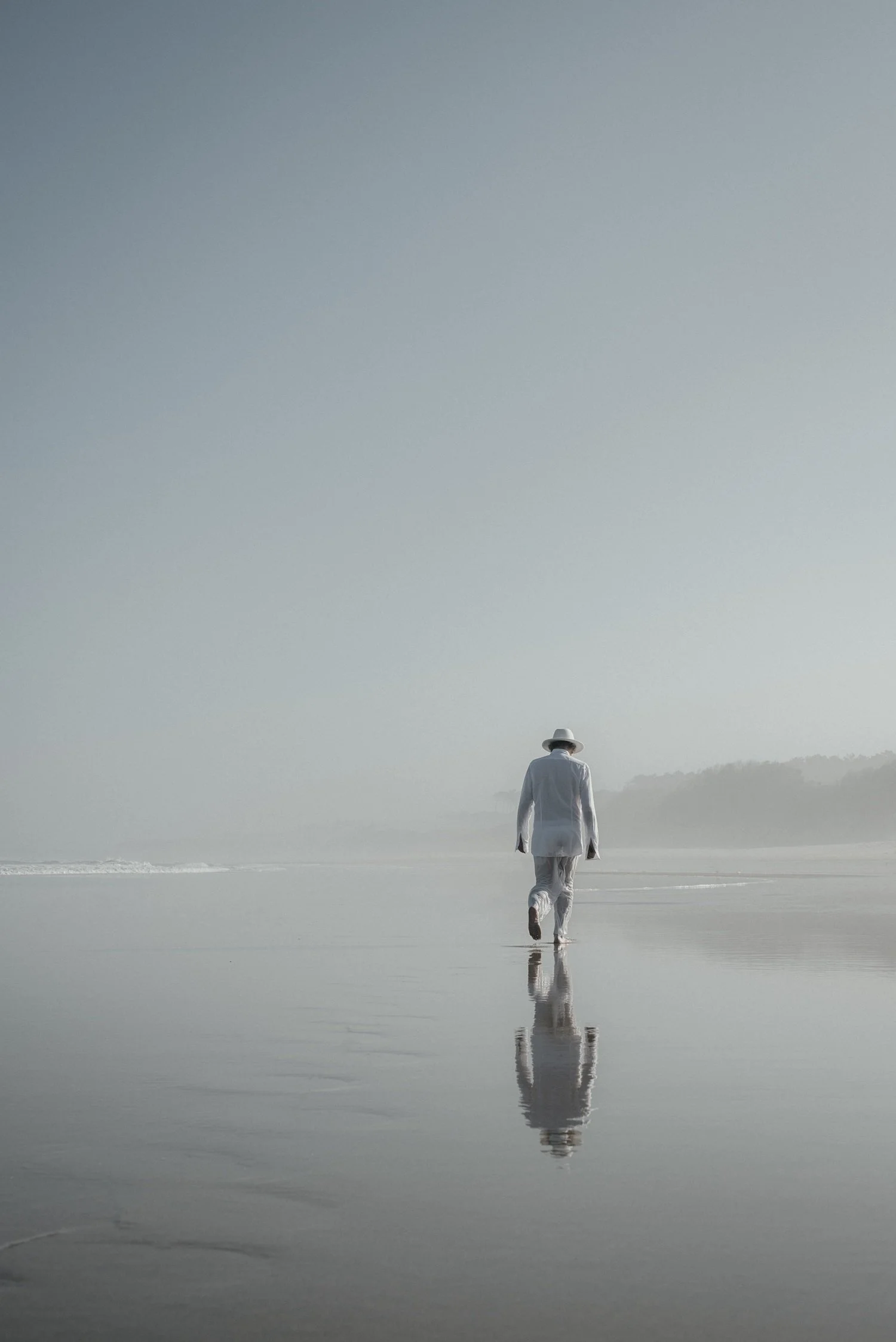 Sandy Kilpatrick in white on quiet coastal landscape