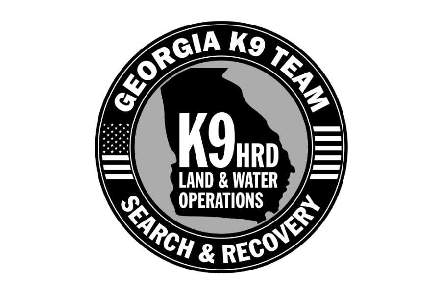 Black and gray circular logo for Georgia K9 Team, with a silhouette of the state of Georgia in the center. The logo includes text for 'K9 HRD Land & Water Operations' and 'Search & Recovery' around the perimeter, along with a small American flag.